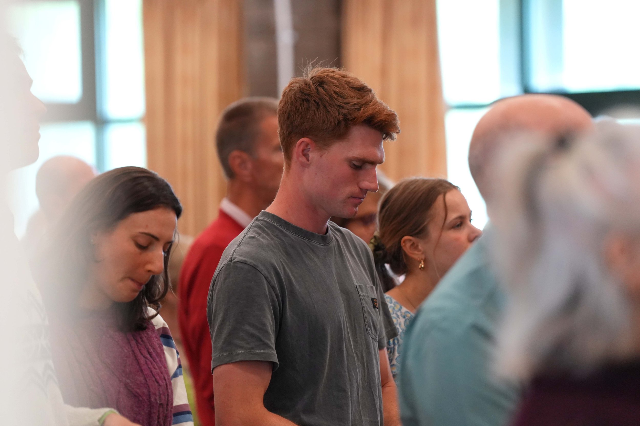 The congregation prays together during a Sunday Service at Grace Community Church