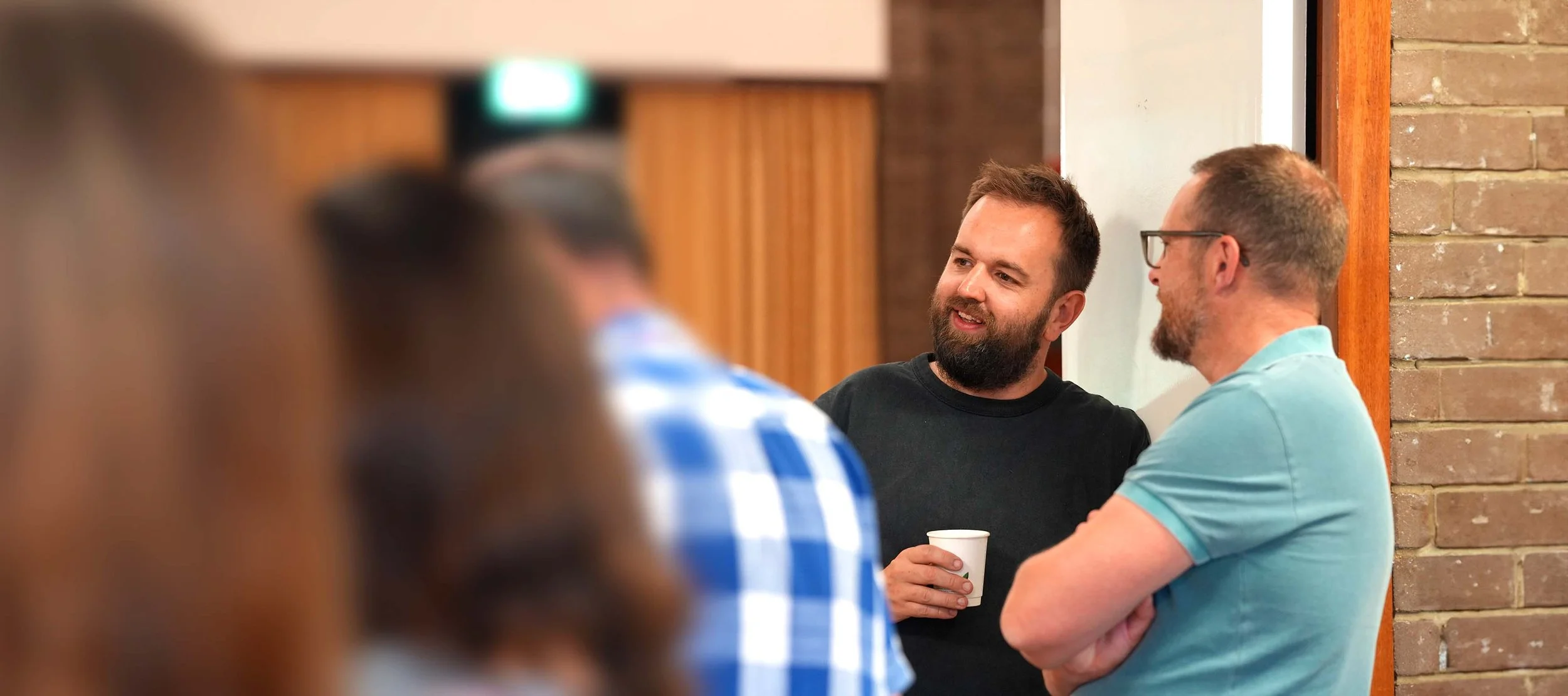 Two men are talking and smiling at each other after a Sunday Service at Grace Community Church. #Church #Community #Grace