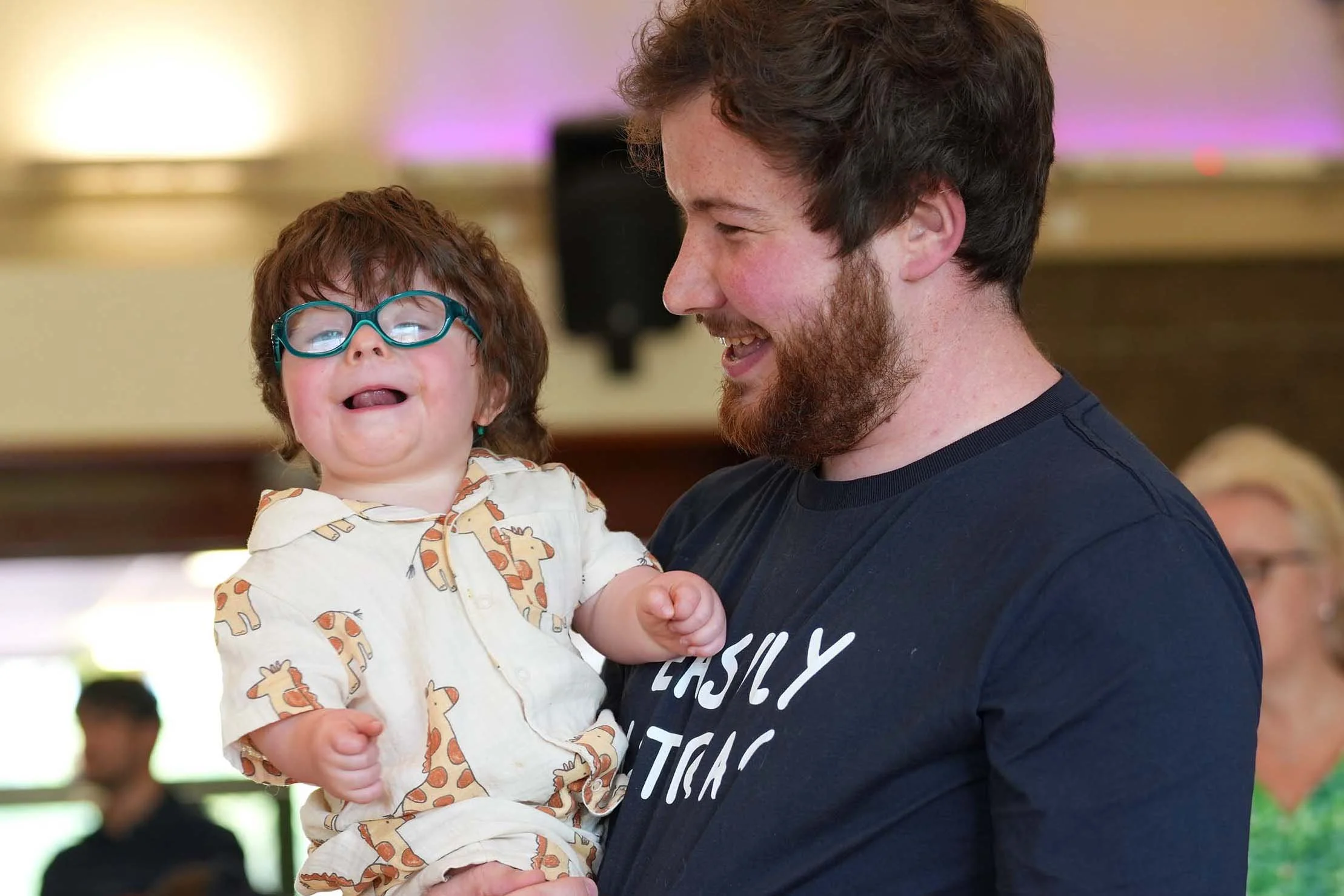 A smiling man holding a young boy at Dadtime - a monthly group for Dads and kids run by Grace Community Church. #Dads #KidsClubs #Kempston