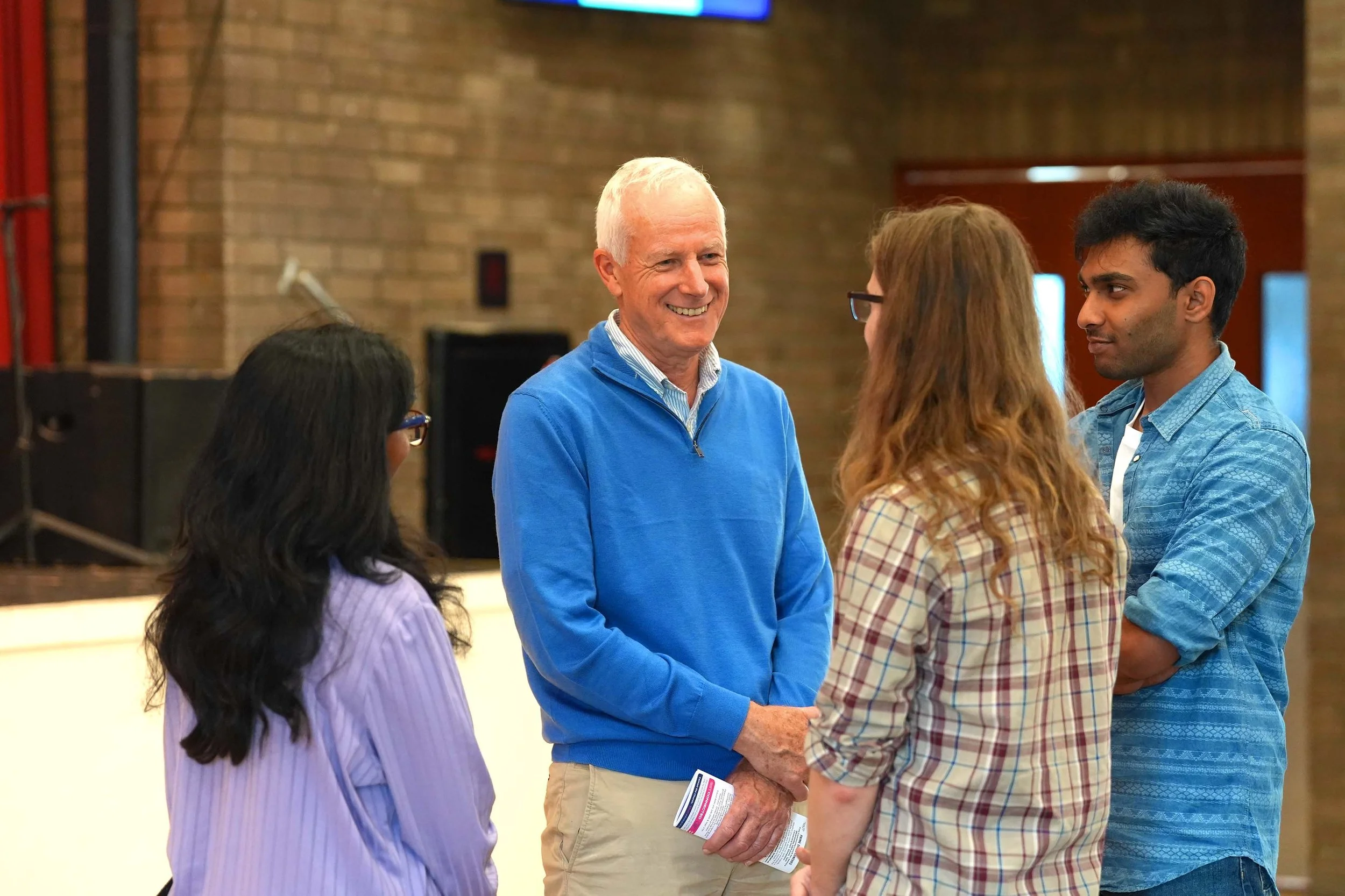 A group of five people, including an older man and four women, engaged in a conversation after a Sunday Service at Grace in Kempston.