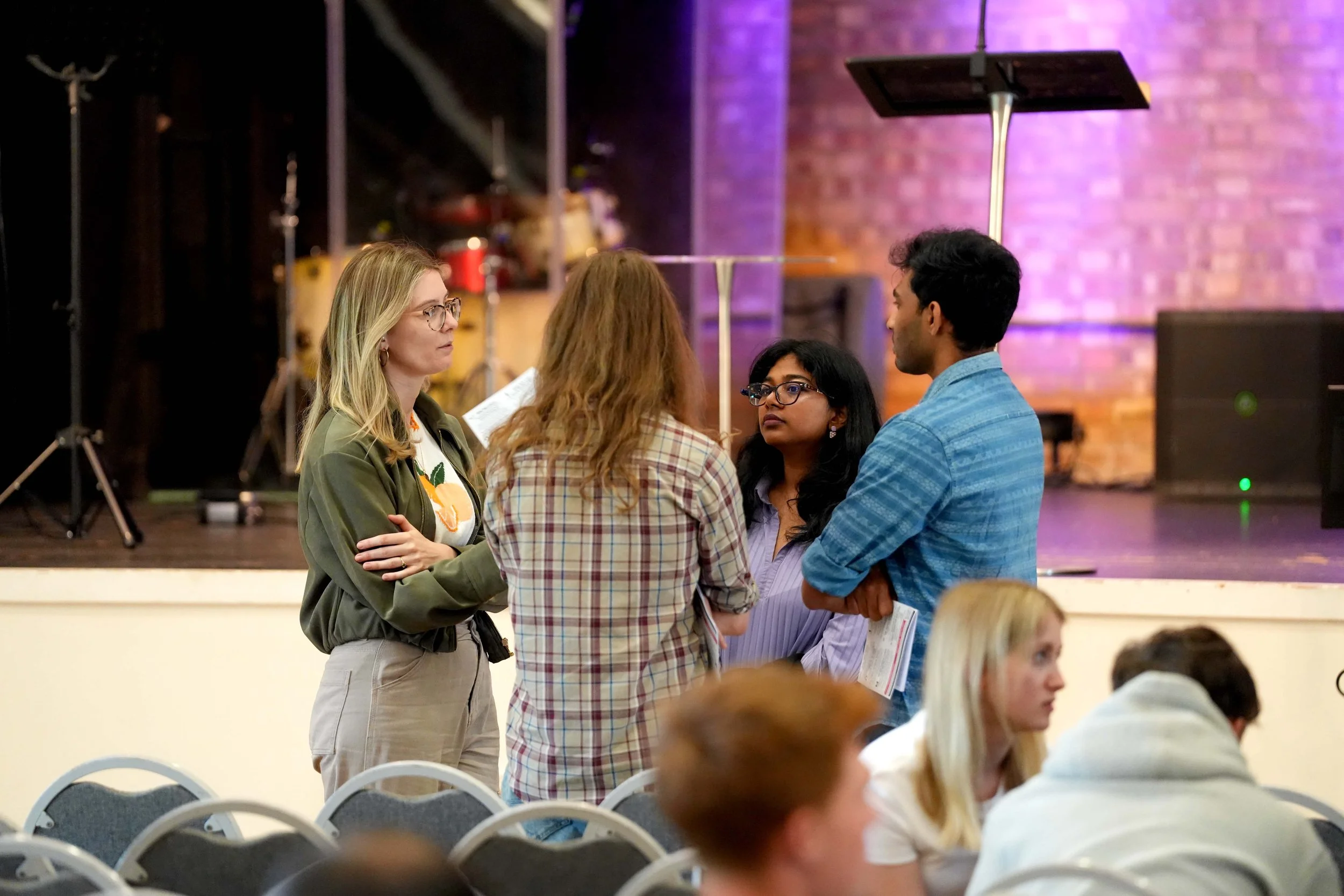 Four women and one man are standing together in conversation after a Sunday Service at church. #Grace #SundayService #church