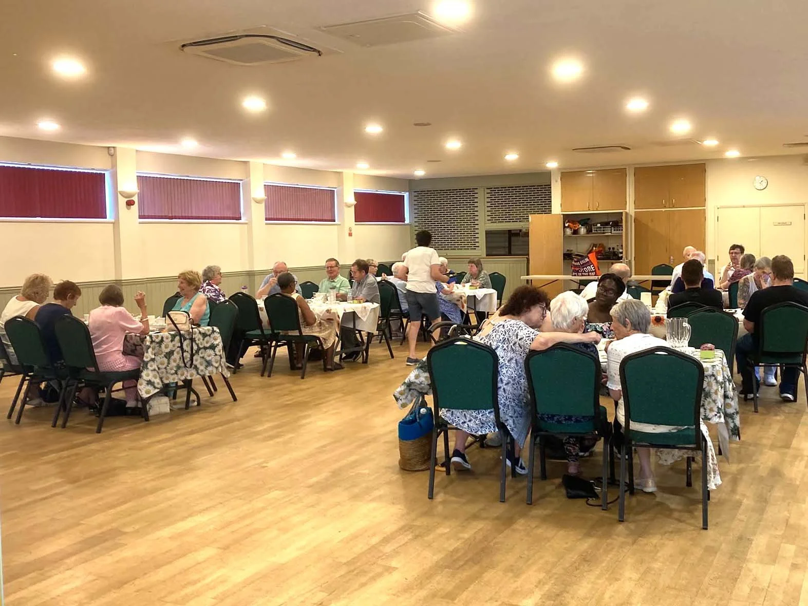 People sitting and eating at one of our community lunches.