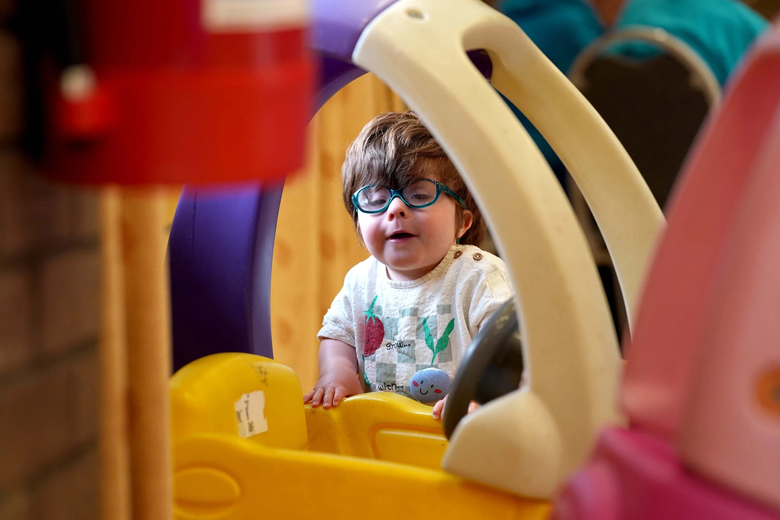 A young boy plays with a toy at Playtime - a family group run by Grace in Kempston