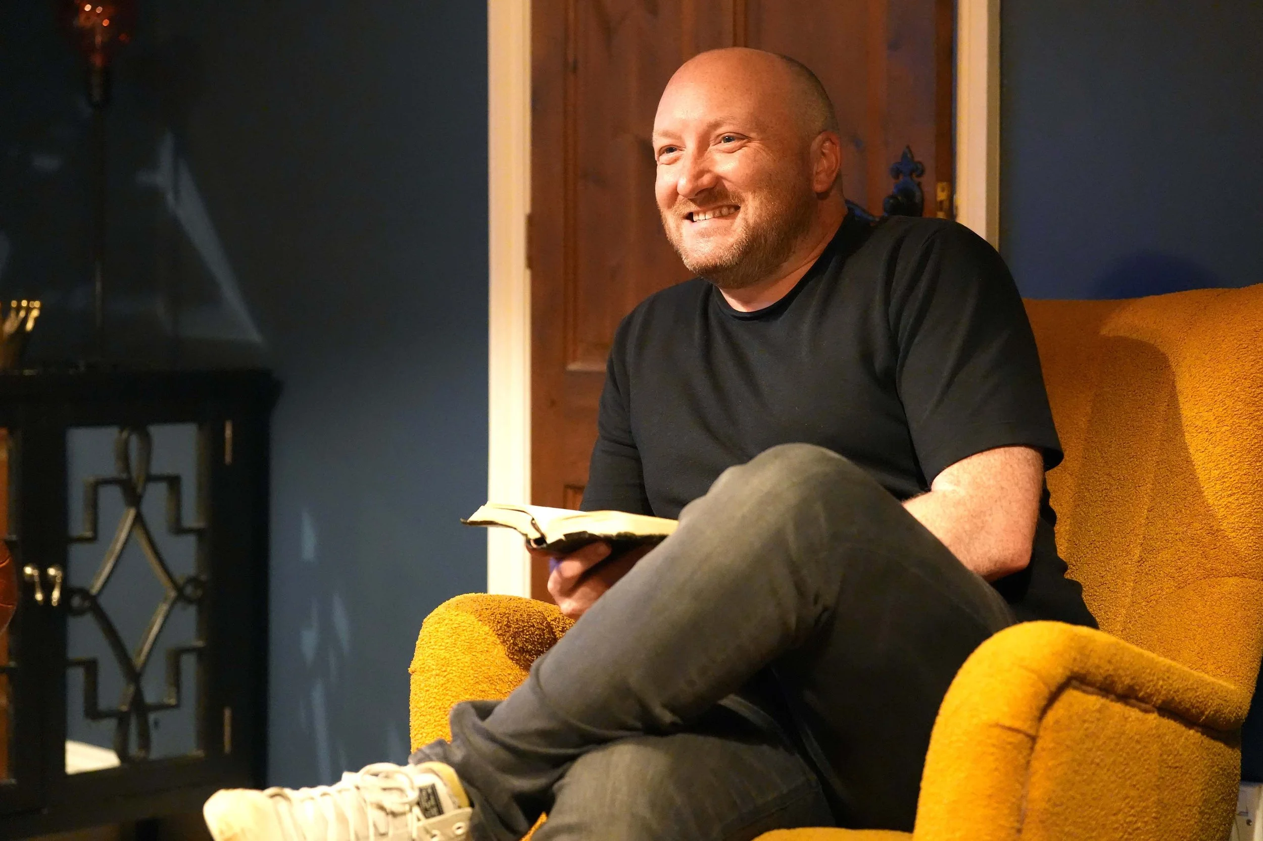 A man smiles and engages in conversation during one of the churches homegroups that run during the week.