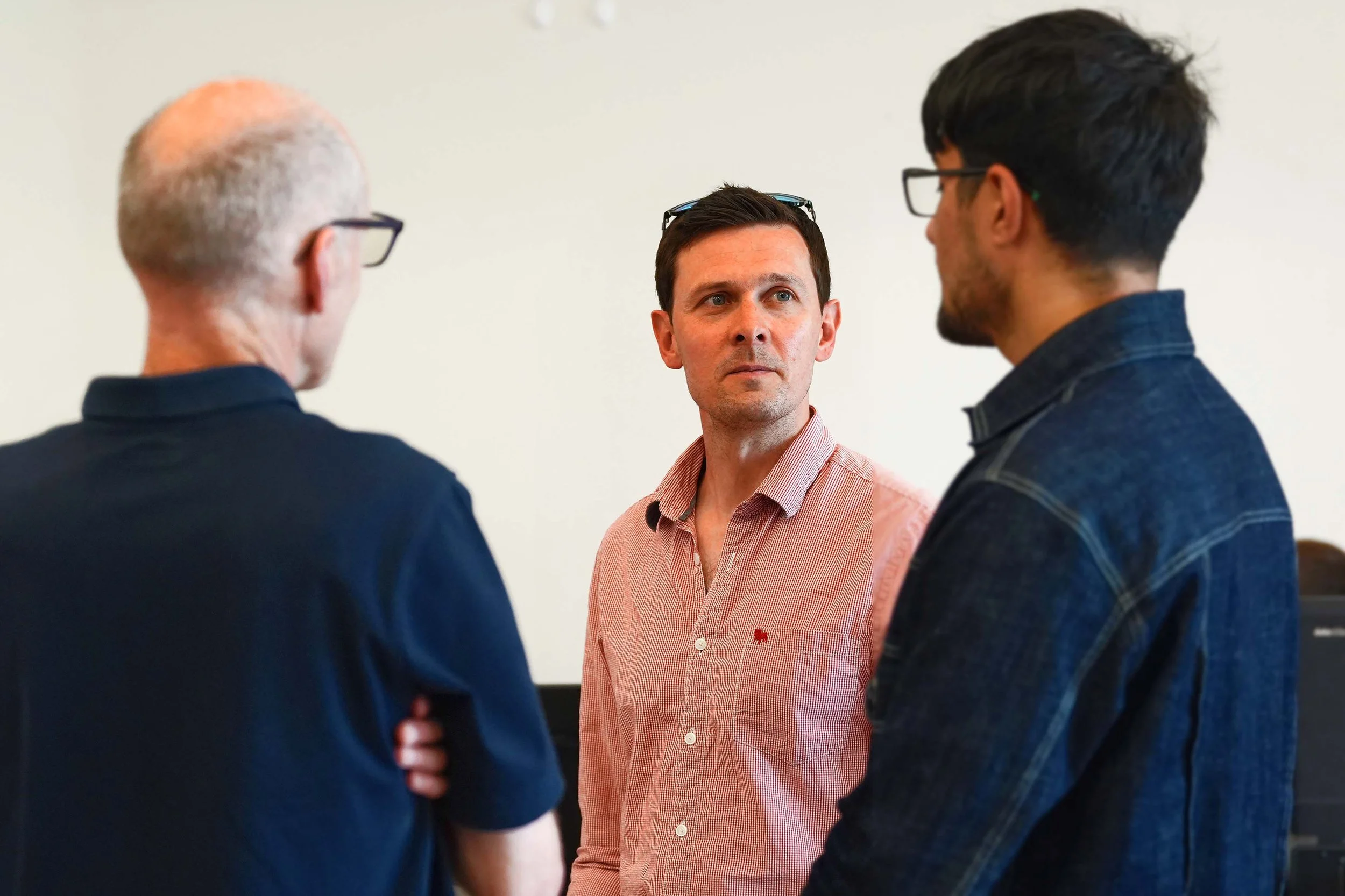 Three men having a conversation together about faith after a Sunday Service at Grace