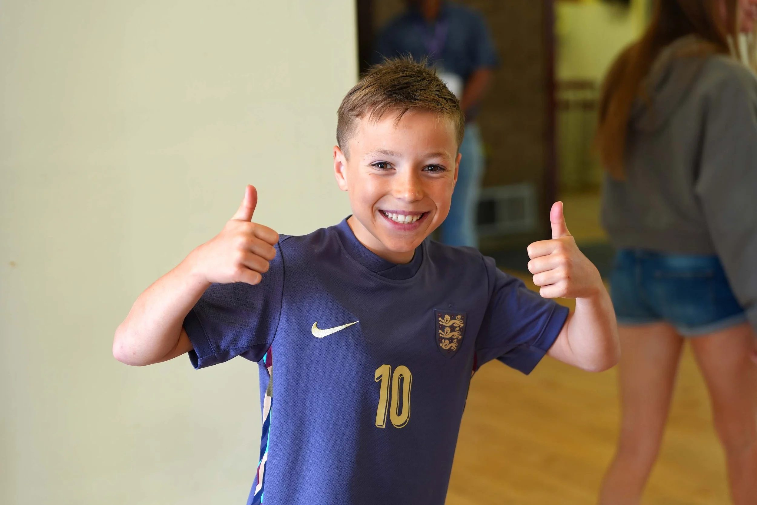 A smiling young boy at a Grace Sunday Service - welcome and accessible to all ages and stages.