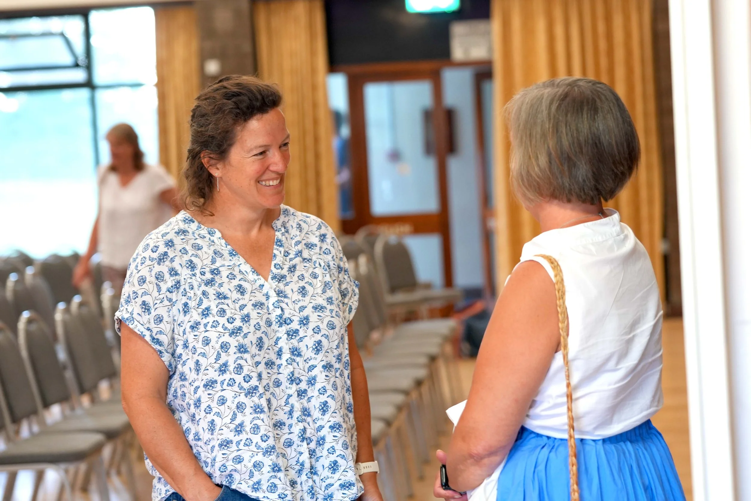 Two women are engaging in a conversation after a Sunday Service at Grace Community Church. #Church #Community #Grace