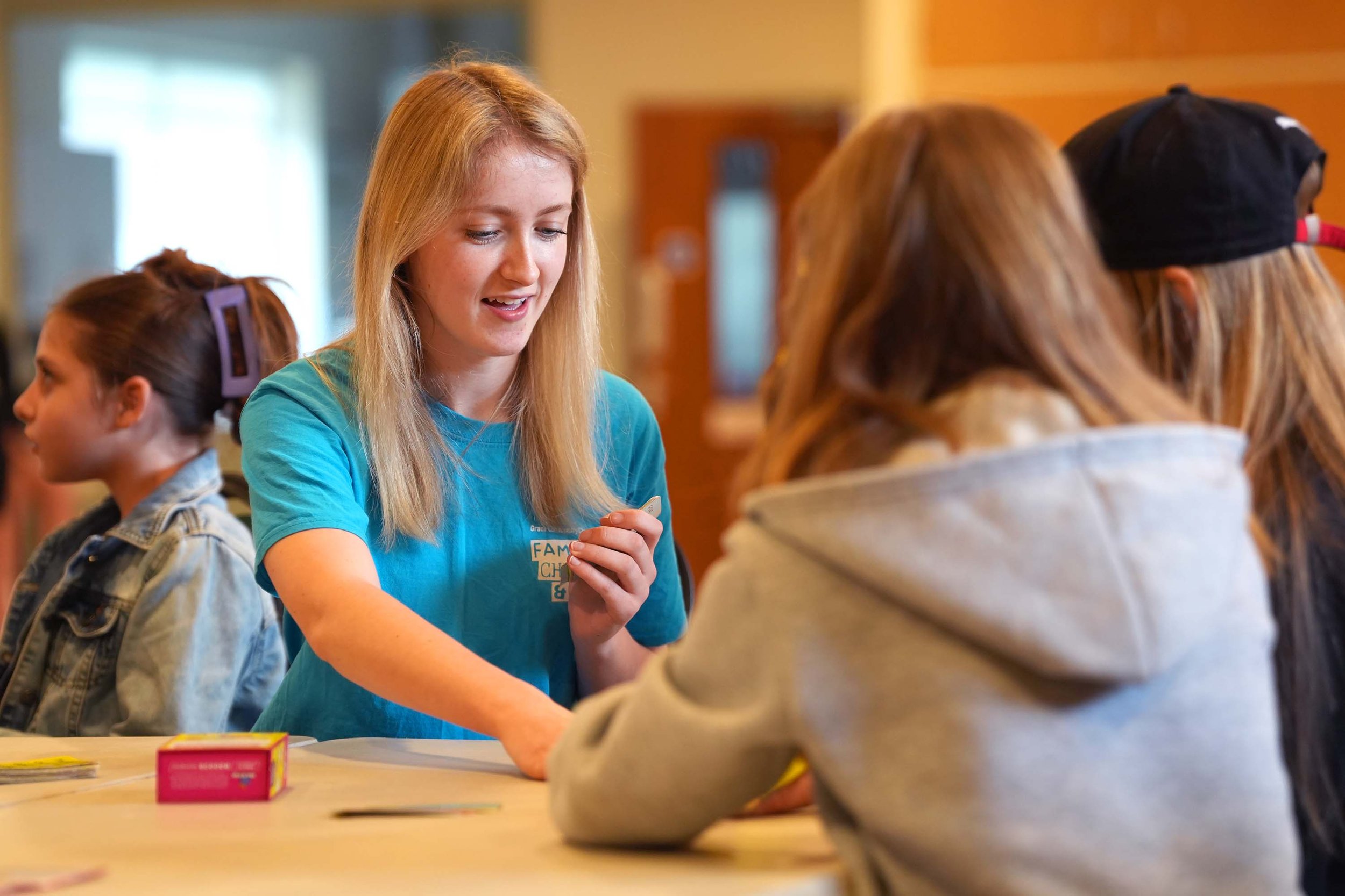 One of the Grace FCY team plays cards with some teens at a youth Club run by Grace Community Church in Kempston.
