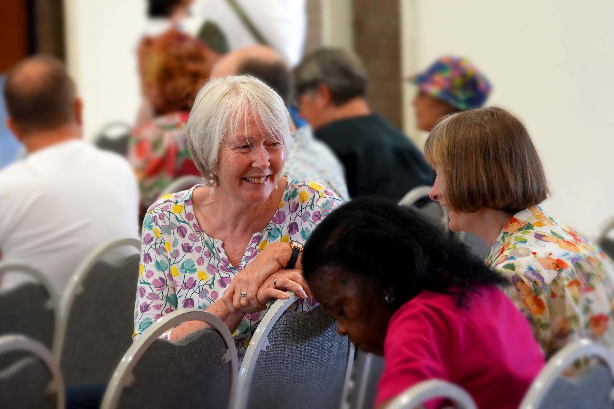 Two women sitting and engaging in conversation after a Sunday Service at Grace Community Church. #Church #Community #family