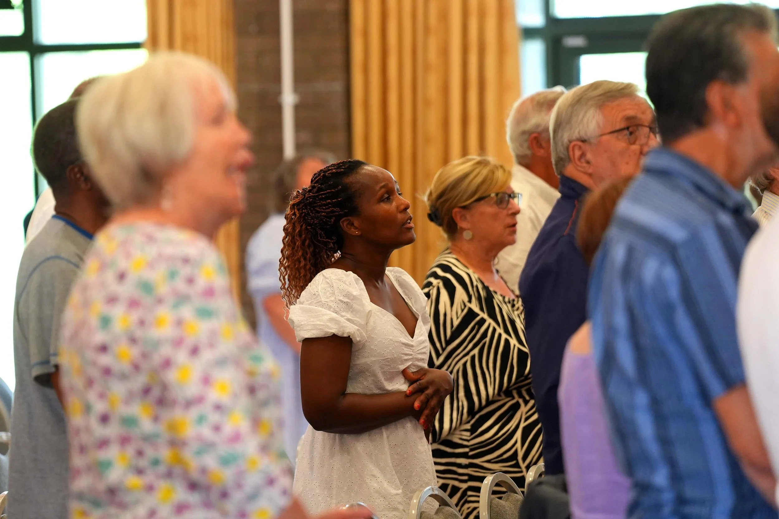 A diverse group of people worshipping together during a Sunday Service at Grace. #Church #SundayServices