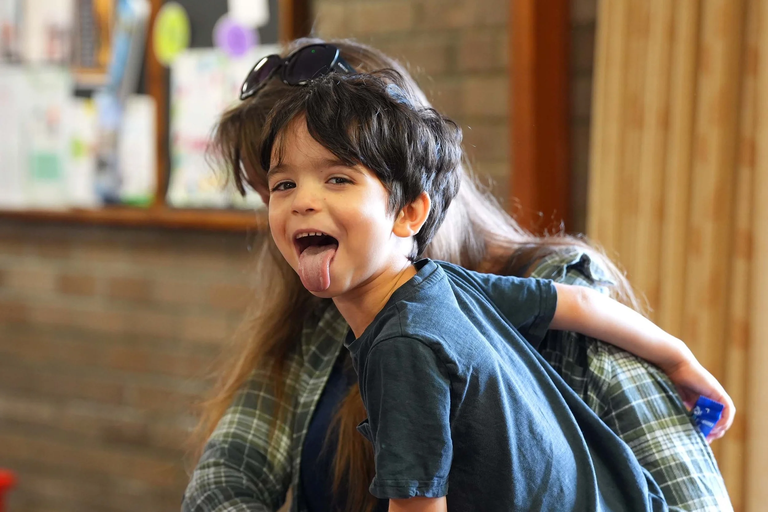 A cheeky young boy sticking his tongue out -after a Sunday Service at Grace Community Church