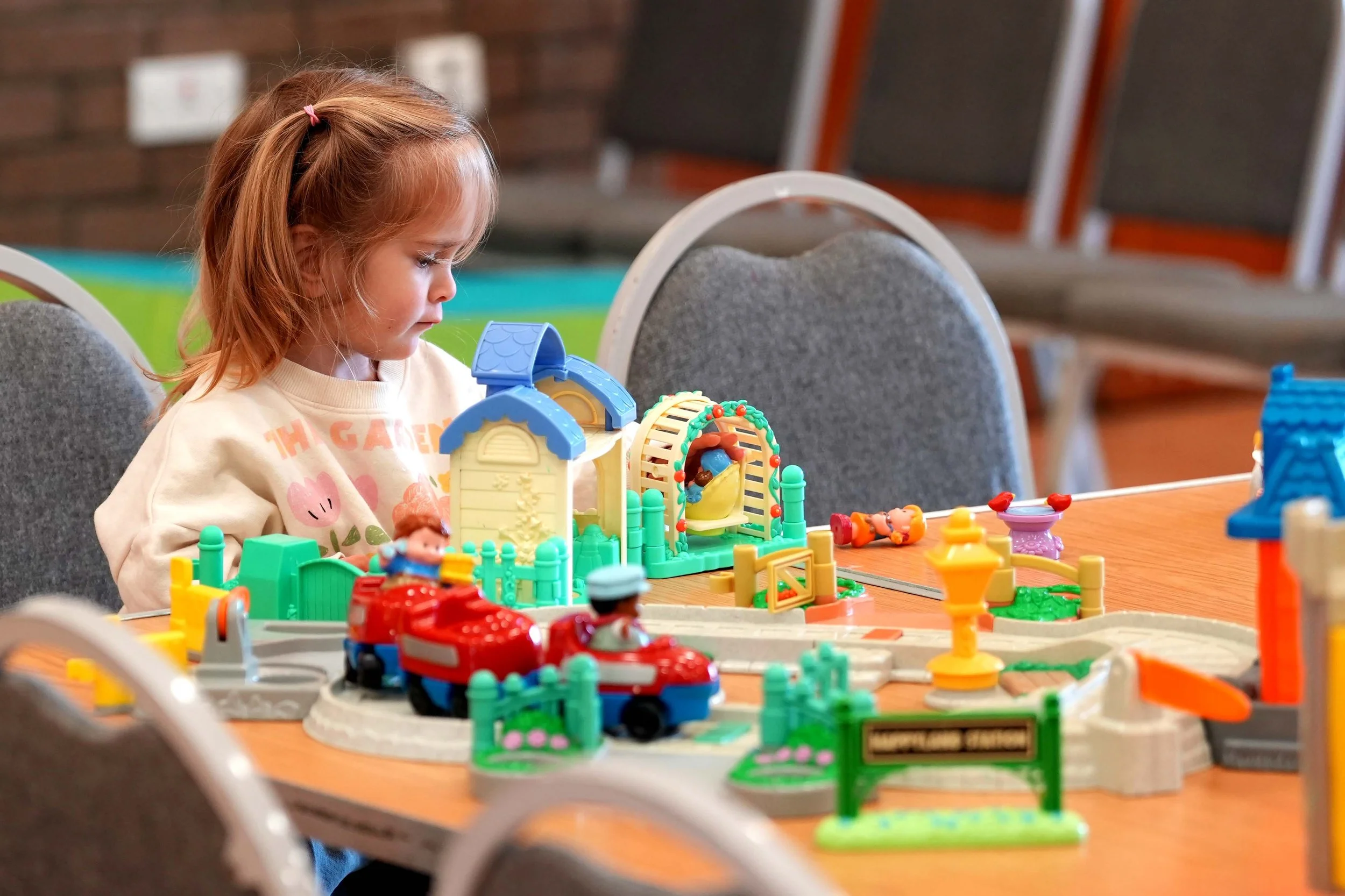 A young girl playing with colorful toys at 'Playtime' - Grace Community Churches family fun group that runs each week in Kempston. #Family #KidsClubs #Kempston