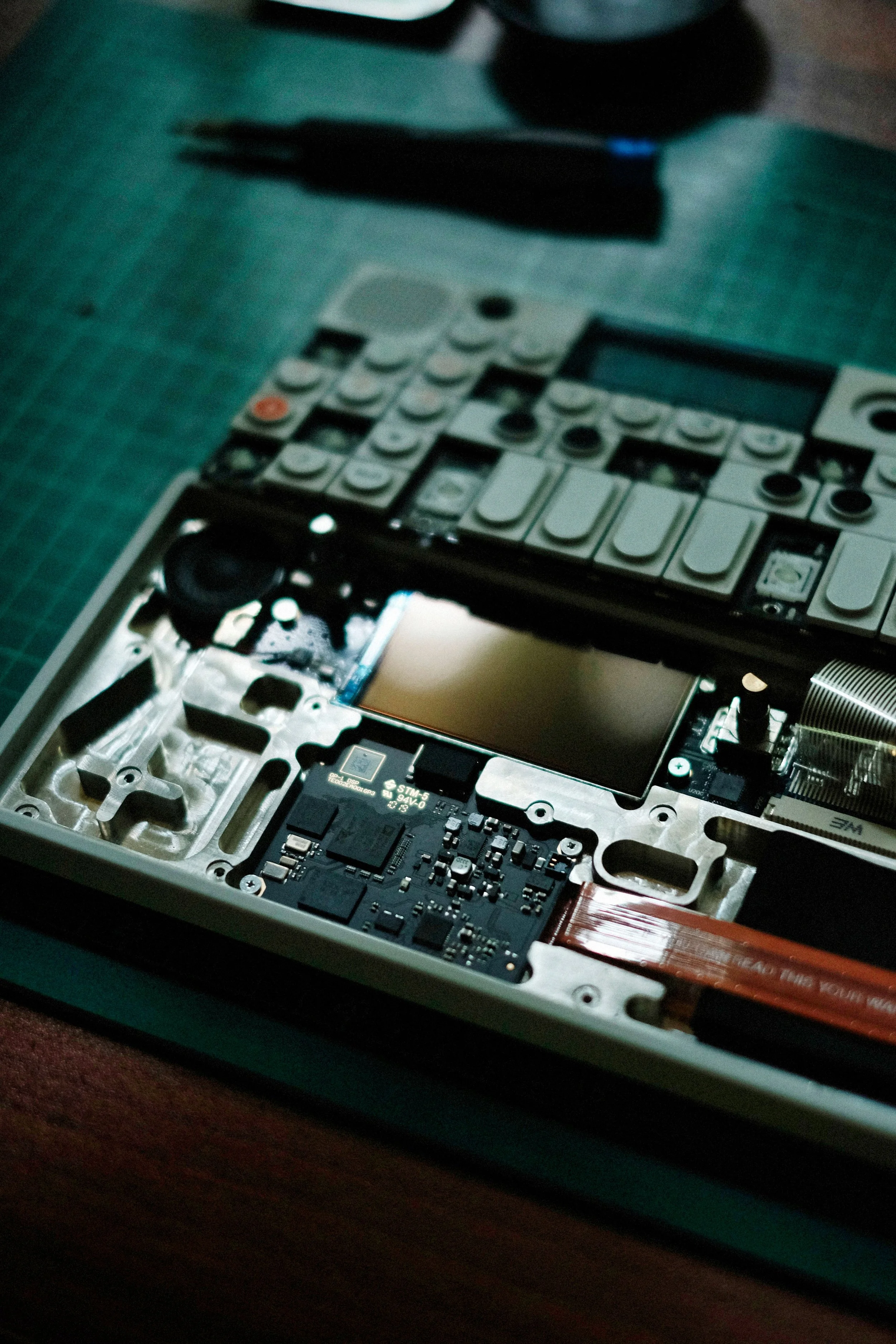 Close-up of the inside of a disassembled electronic device, showing circuit boards and components.