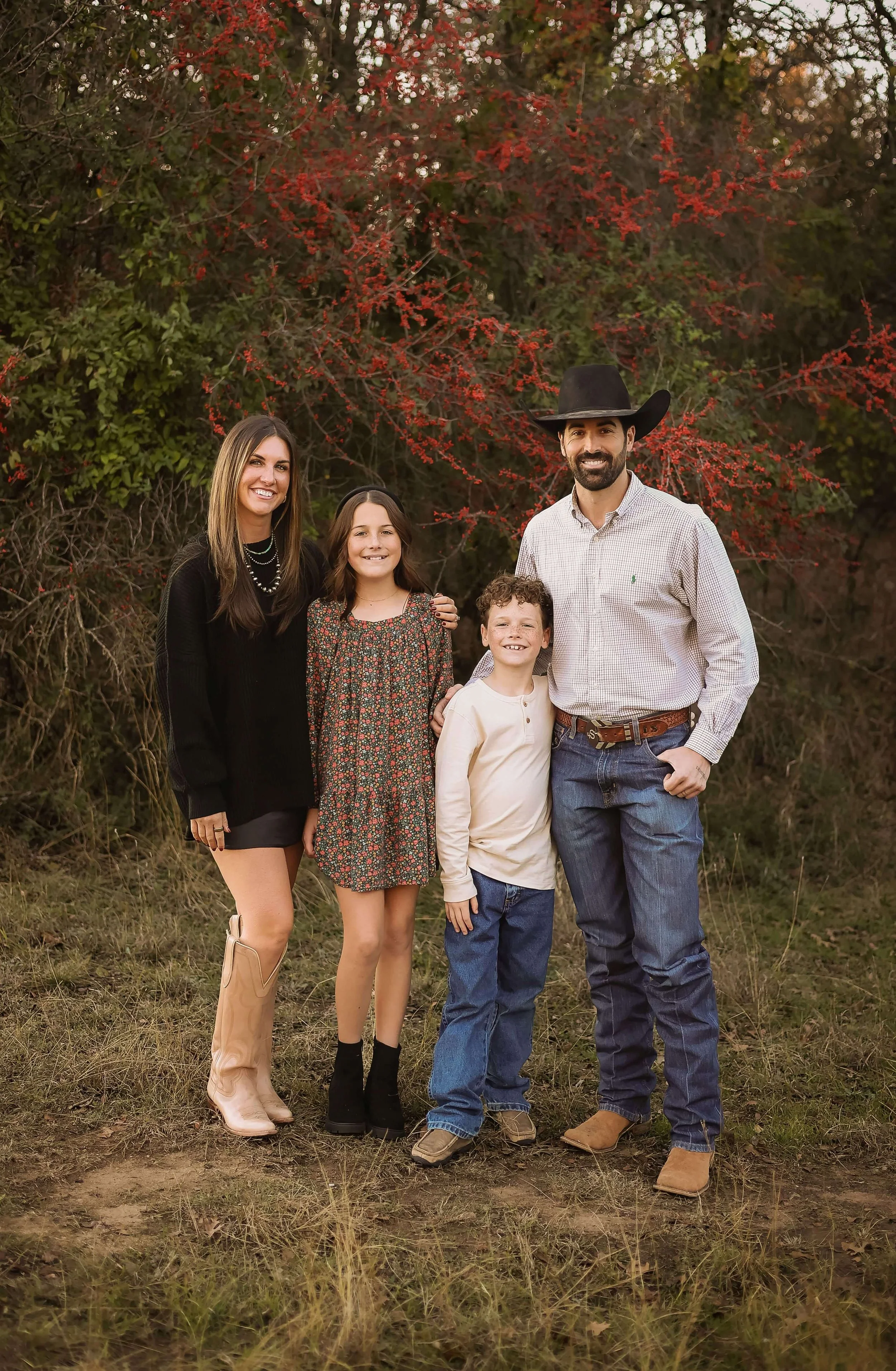 Ian Sears, the owner of Fig Tree Homes, with his family in front of a tree in the fall.