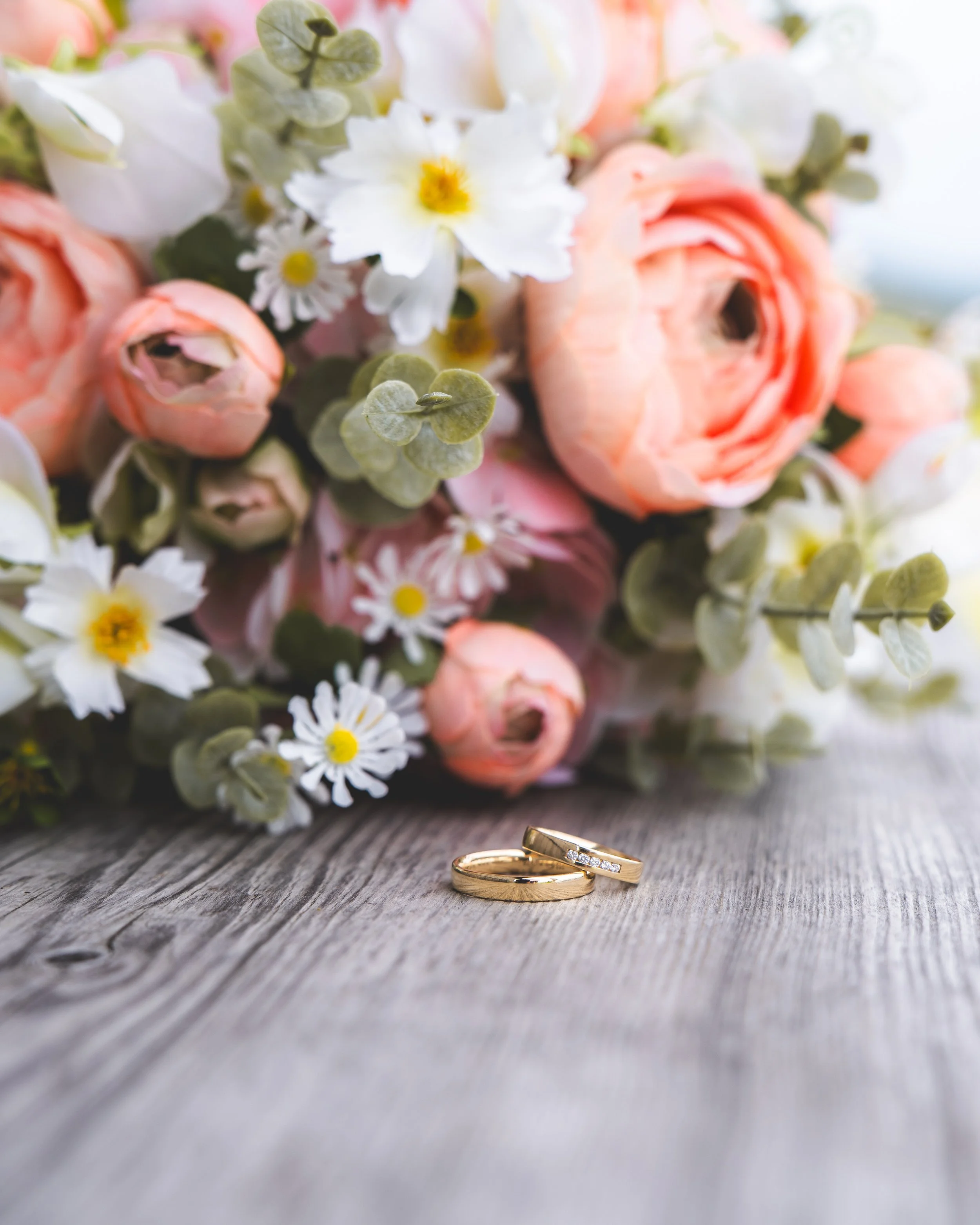 Brautstrauß mit rosa und weißen Blumen und Eheringen