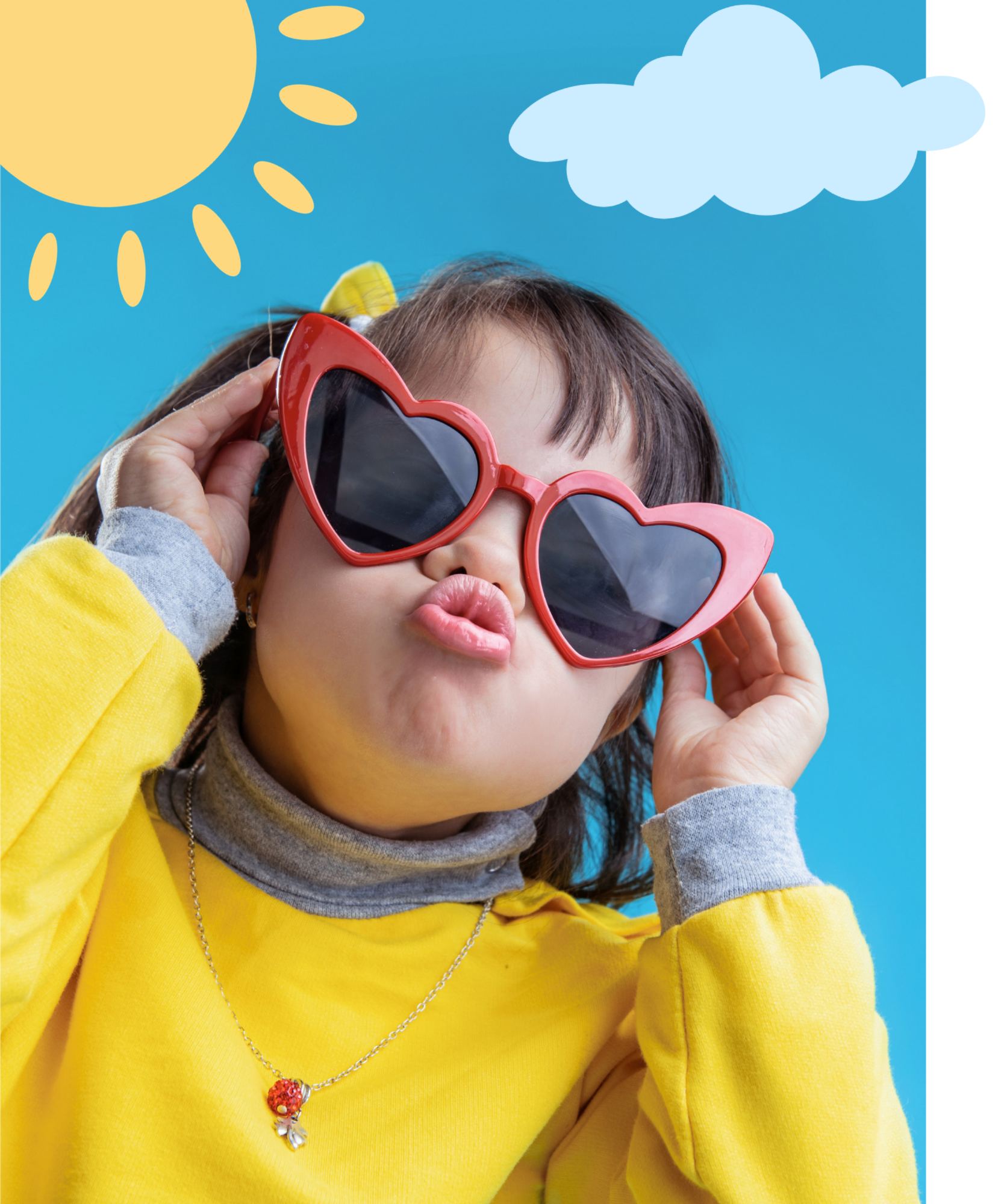 A young girl with brown hair in pigtails, wearing red heart-shaped sunglasses, puckering her lips during speech therapy for kids in Knoxville, TN