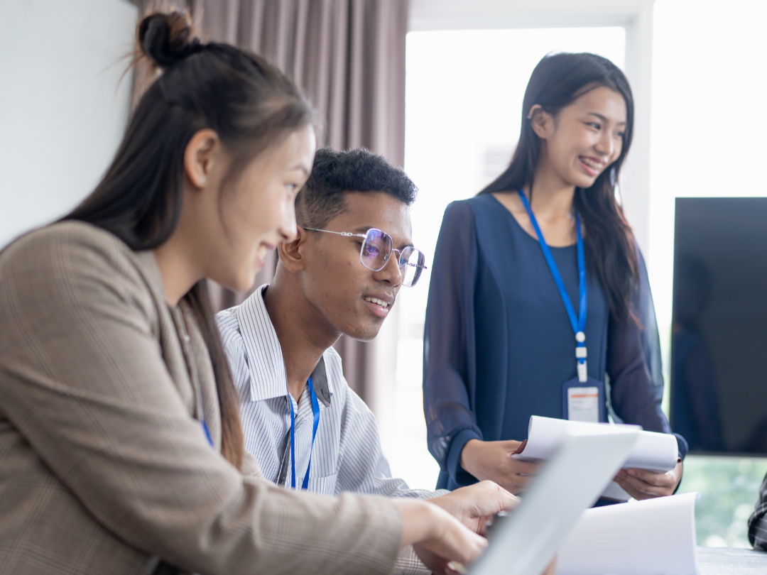 A corporate culture and communications consultant in Singapore helping evolving business team unlock employee potential during a workplace meeting.