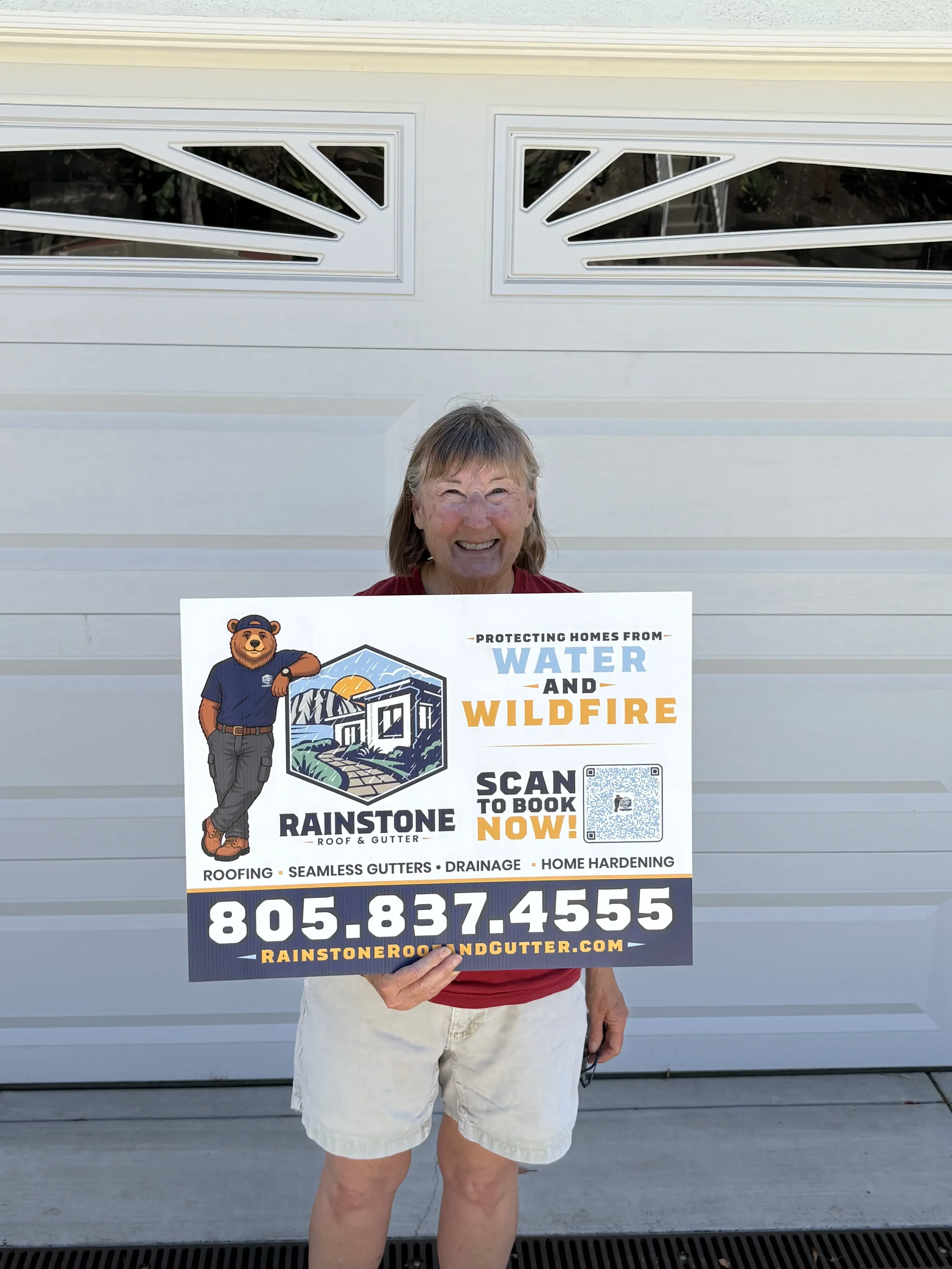 Rainstone Roof & Gutter customer celebrating a completed home protection project.