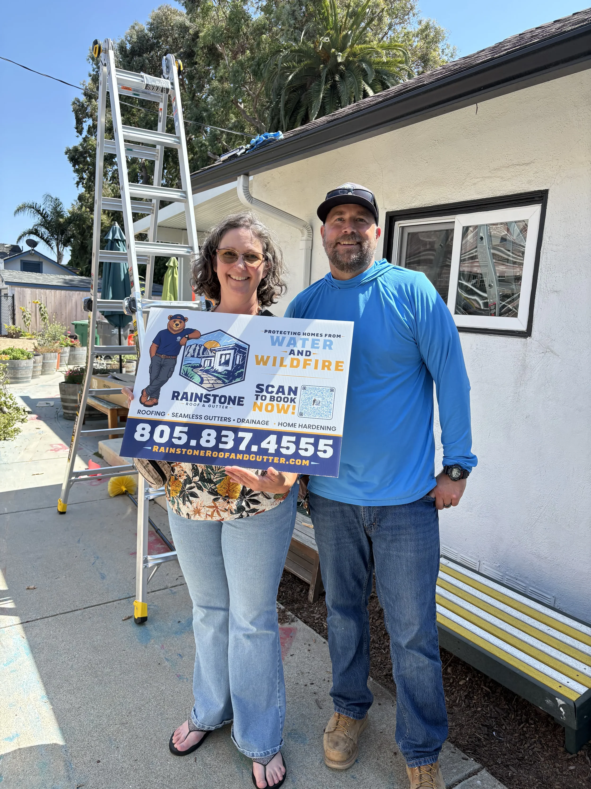Happy Rainstone Roof & Gutter customer with Rainstone owner after a completed home improvement project.