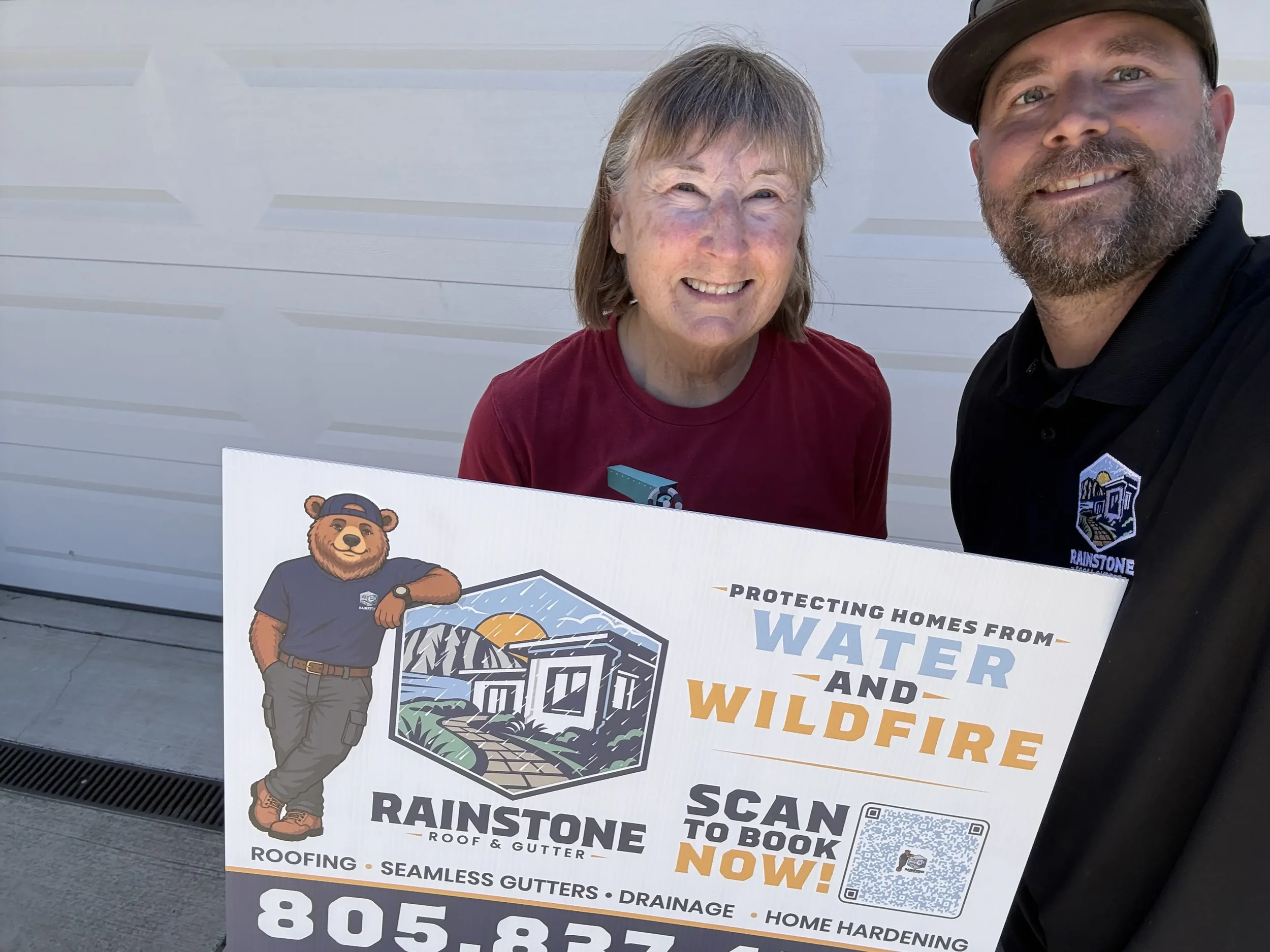 Happy homeowner with Rainstone Roof & Gutter after a completed roofing and gutter project.