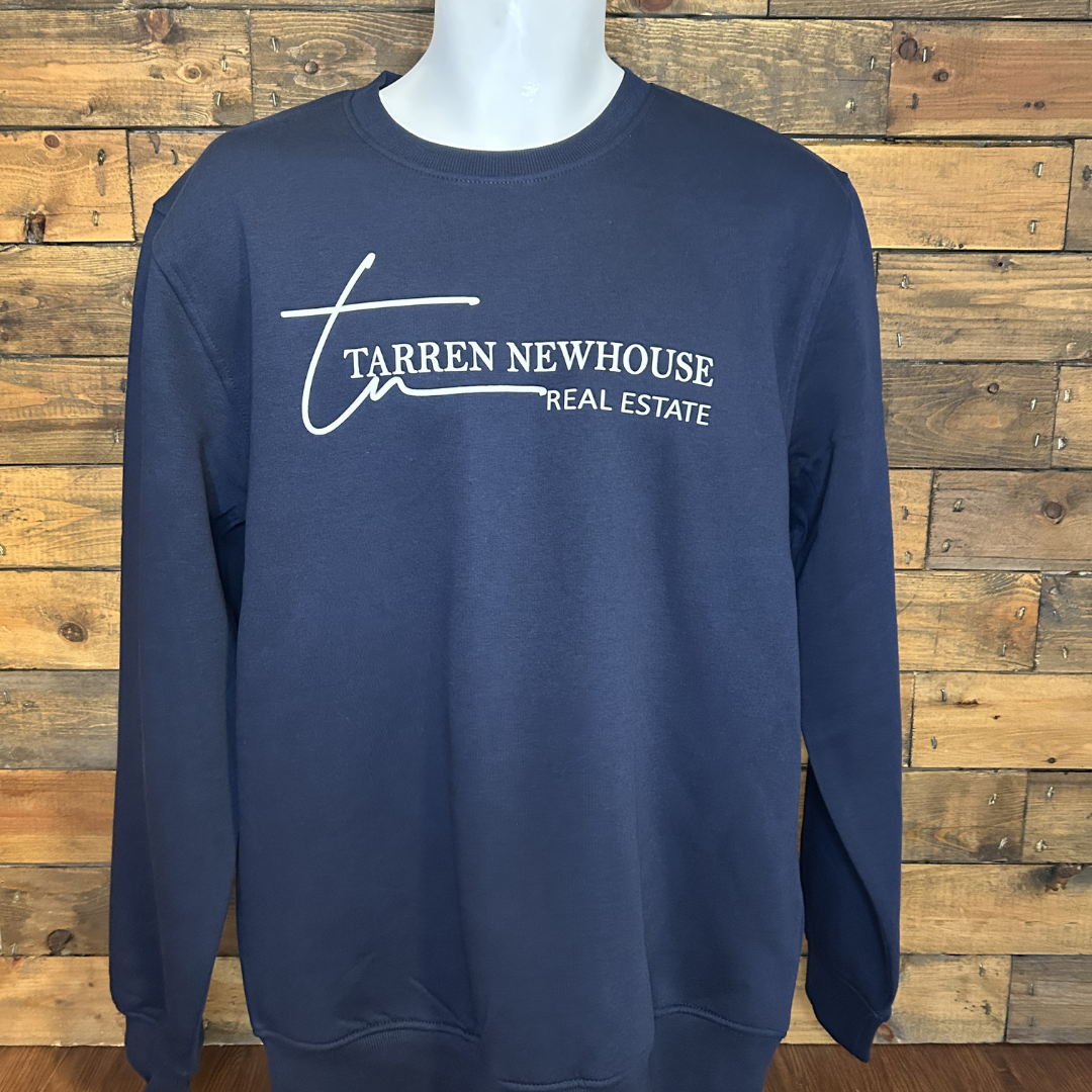 Navy blue sweatshirt with white text and signature logo that reads 'Tarren Newhouse Real Estate', displayed on a mannequin against a wooden wall.