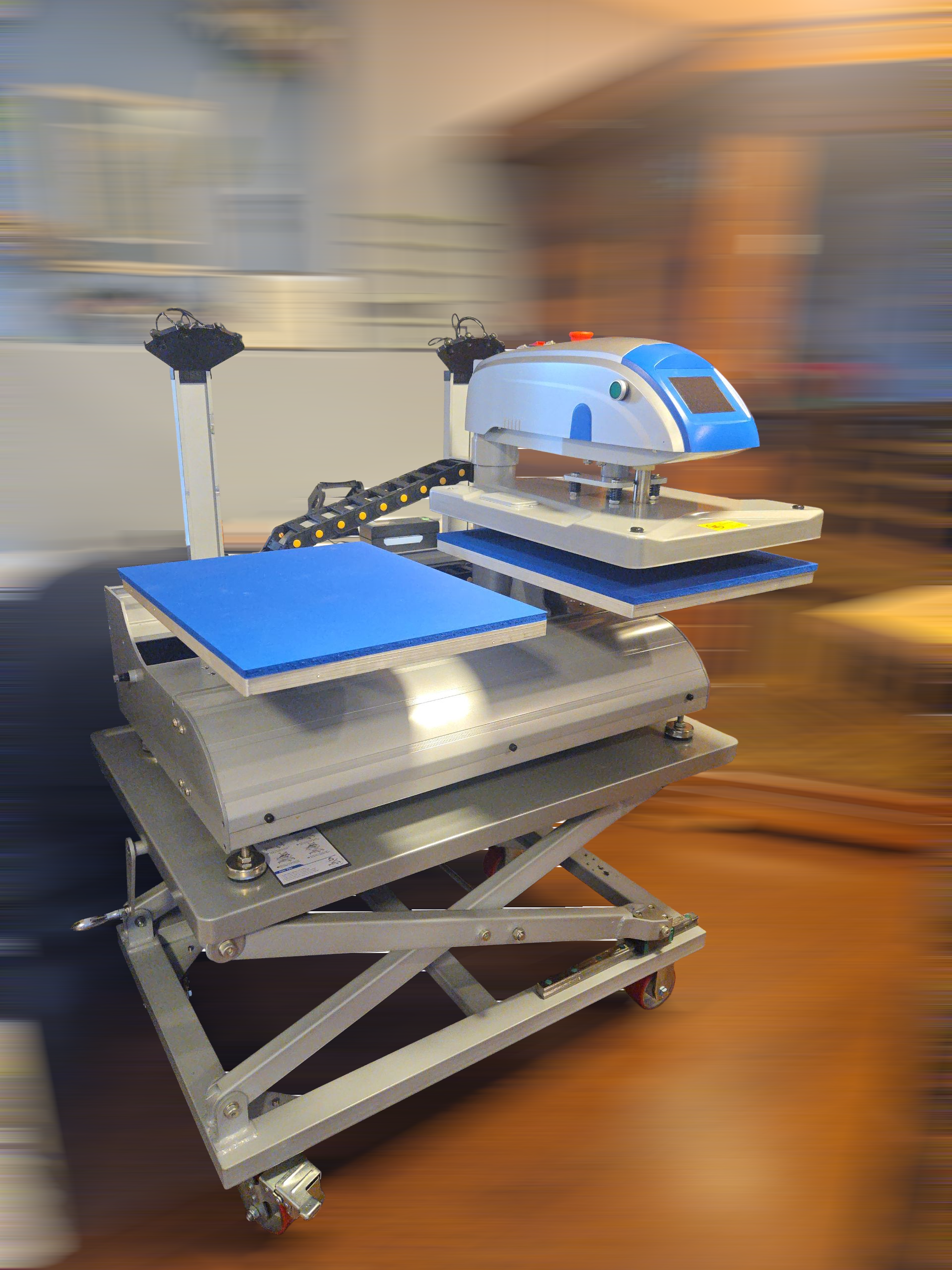A robotic surgical arm on a metal table in a medical or research facility.
