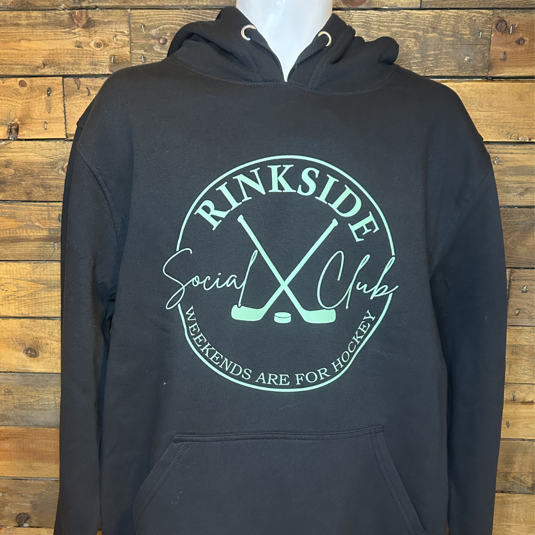 Black hoodie with a circular logo featuring two crossed hockey sticks, a puck, and the text "RINKSIDE Social Club" with the slogan "Weekends are for hockey."
