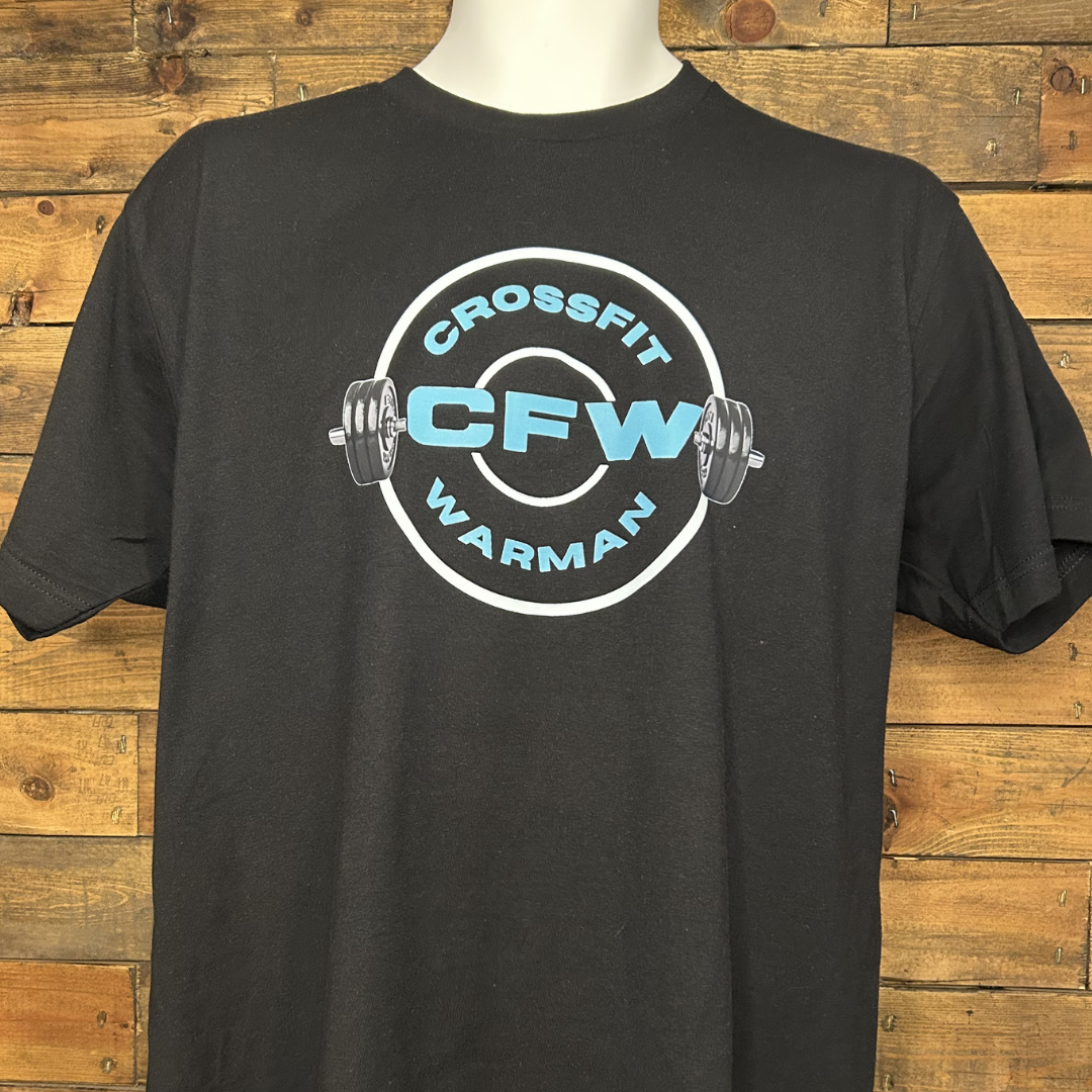 Black t-shirt with CrossFit logo featuring weightlifting plates and the words 'CrossFit Warman' in blue and white, displayed against a wooden background.