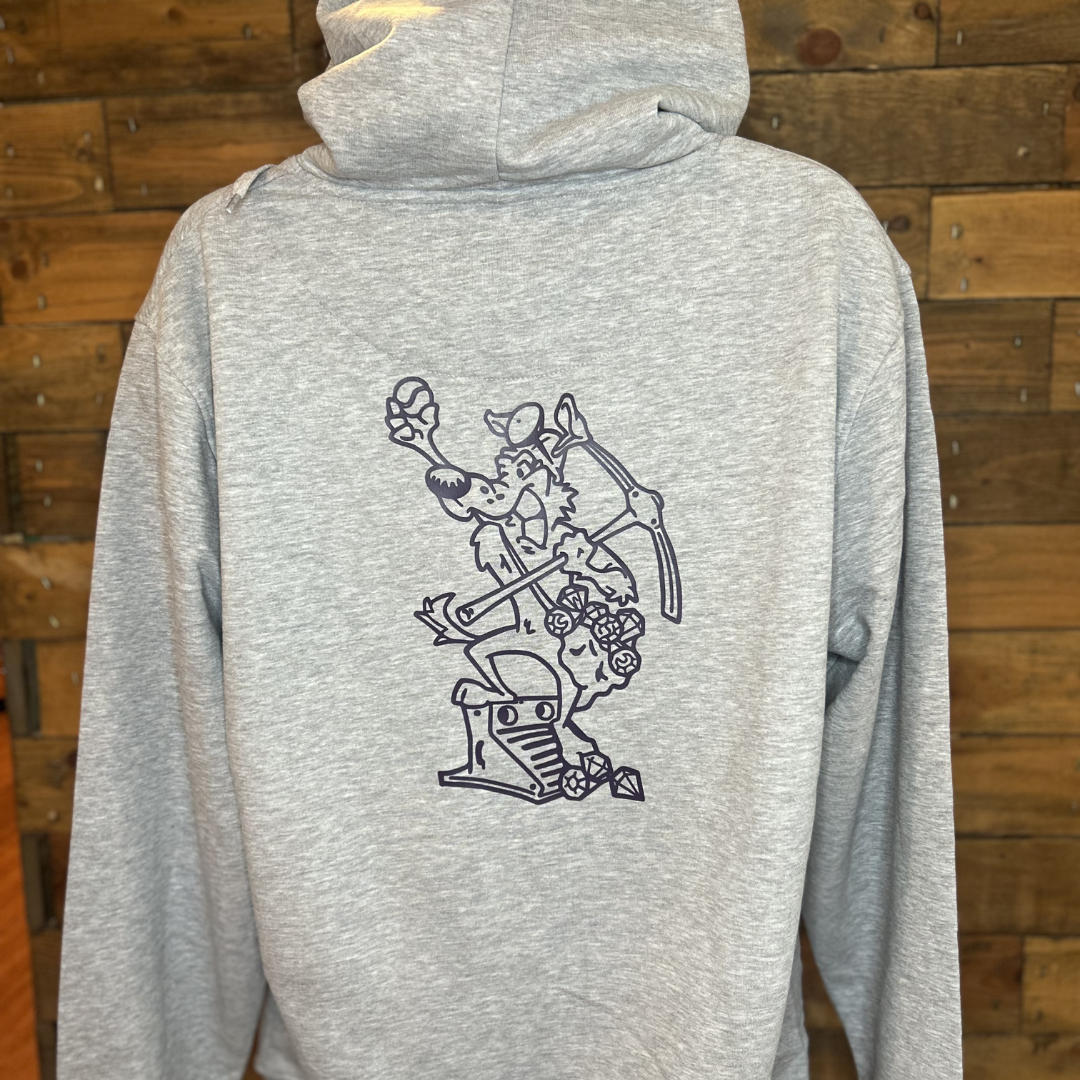 Gray hoodie with line drawing of a cartoon crocodile wearing a hat, holding a pickaxe, and standing on a treasure chest.
