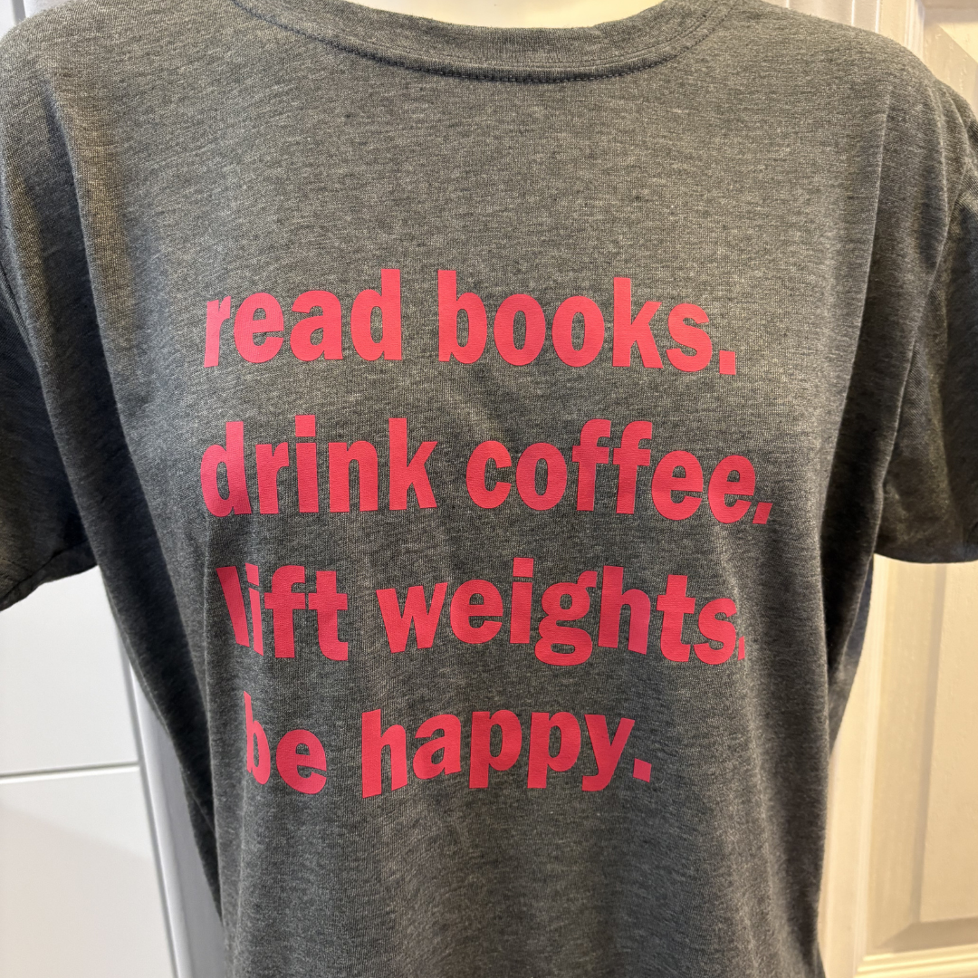 Gray T-shirt with pink text that reads 'read books. drink coffee, lift weights, be happy.'