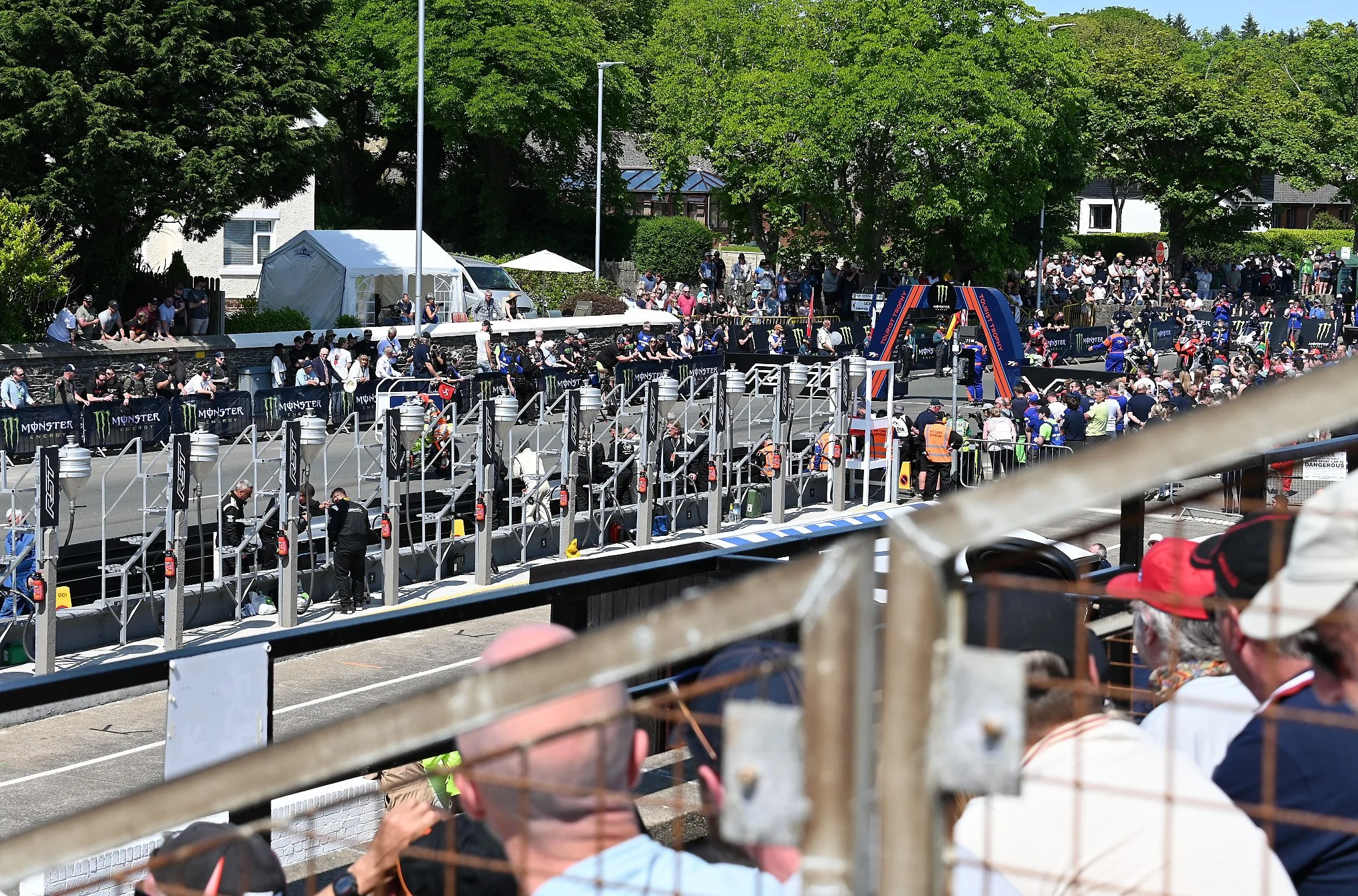 A view from the Grandstands on Glencrutchery Road.  Both the Grandstands and Pits are permanent structures. The riders are sent off every 10 seconds, and after the last rider clears the grid, the inflable arch is removed and the road is cleared befor