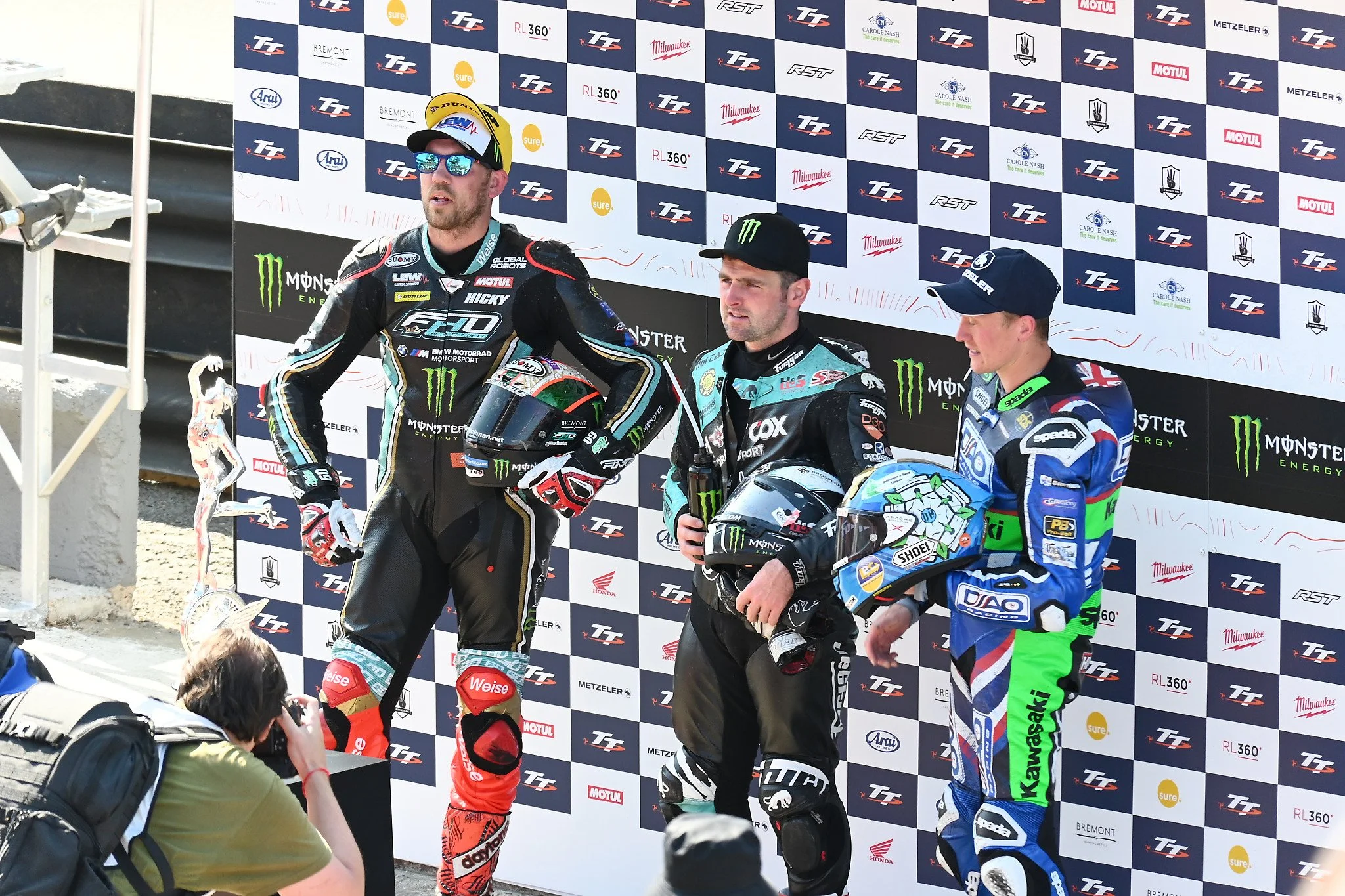 In a scene that would be repeated several times during the 2023 IOM TT, Peter Hickman (l) Michael Dunlop (c) and Dean Harrison (r) would all share the podium. For the 2023 RST Superbike TT Race, Michael Dunlop would take 1st Place, Peter Hickman 2nd,