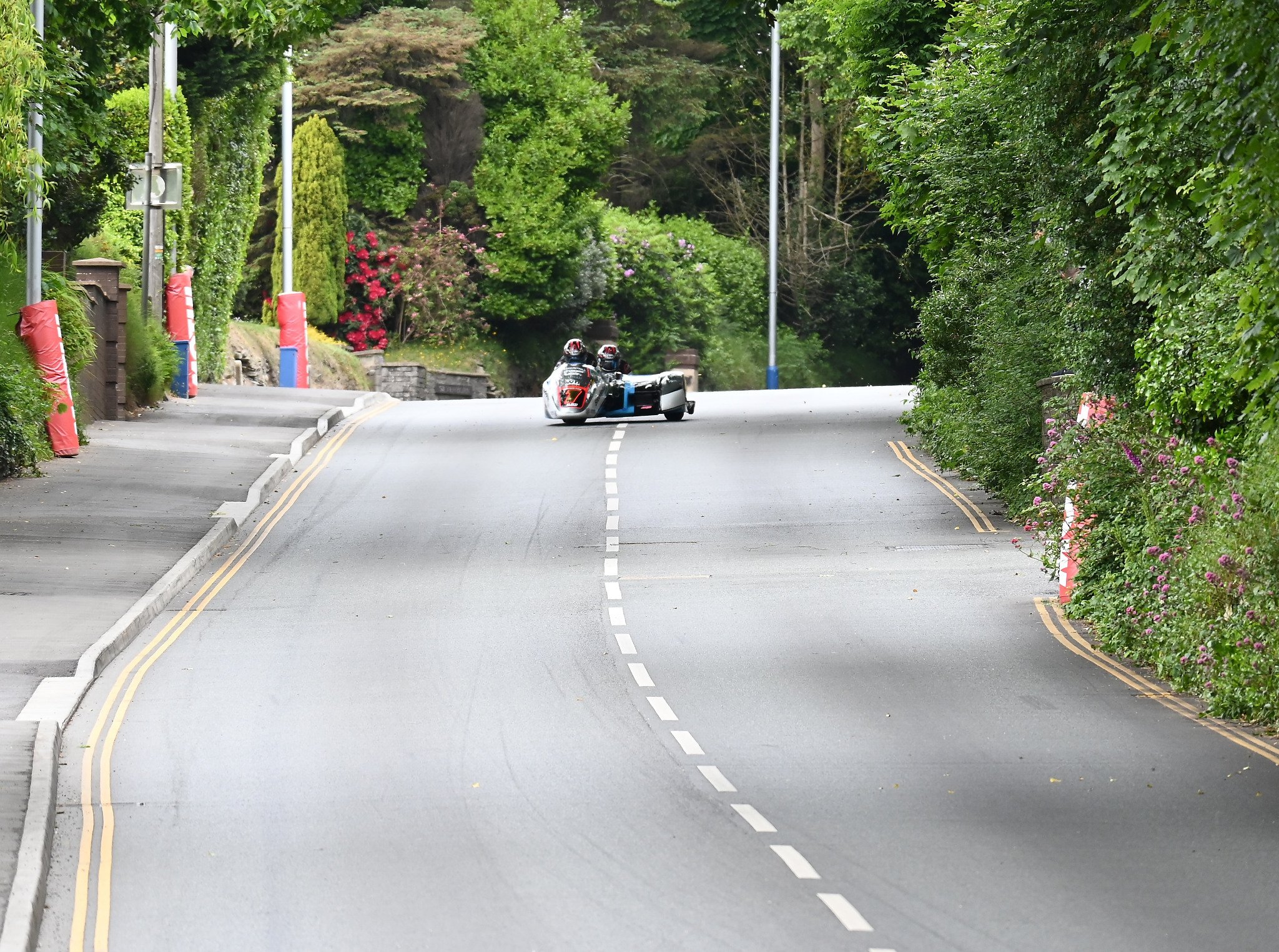 One of the first Sidecar teams comes down the bottom of Quarterbridge Road before the right turn onto Peel Road at the start of the 3Wheeling.Media Sidecar TT Race 2. Photo taken at Quarterbridge Road.
