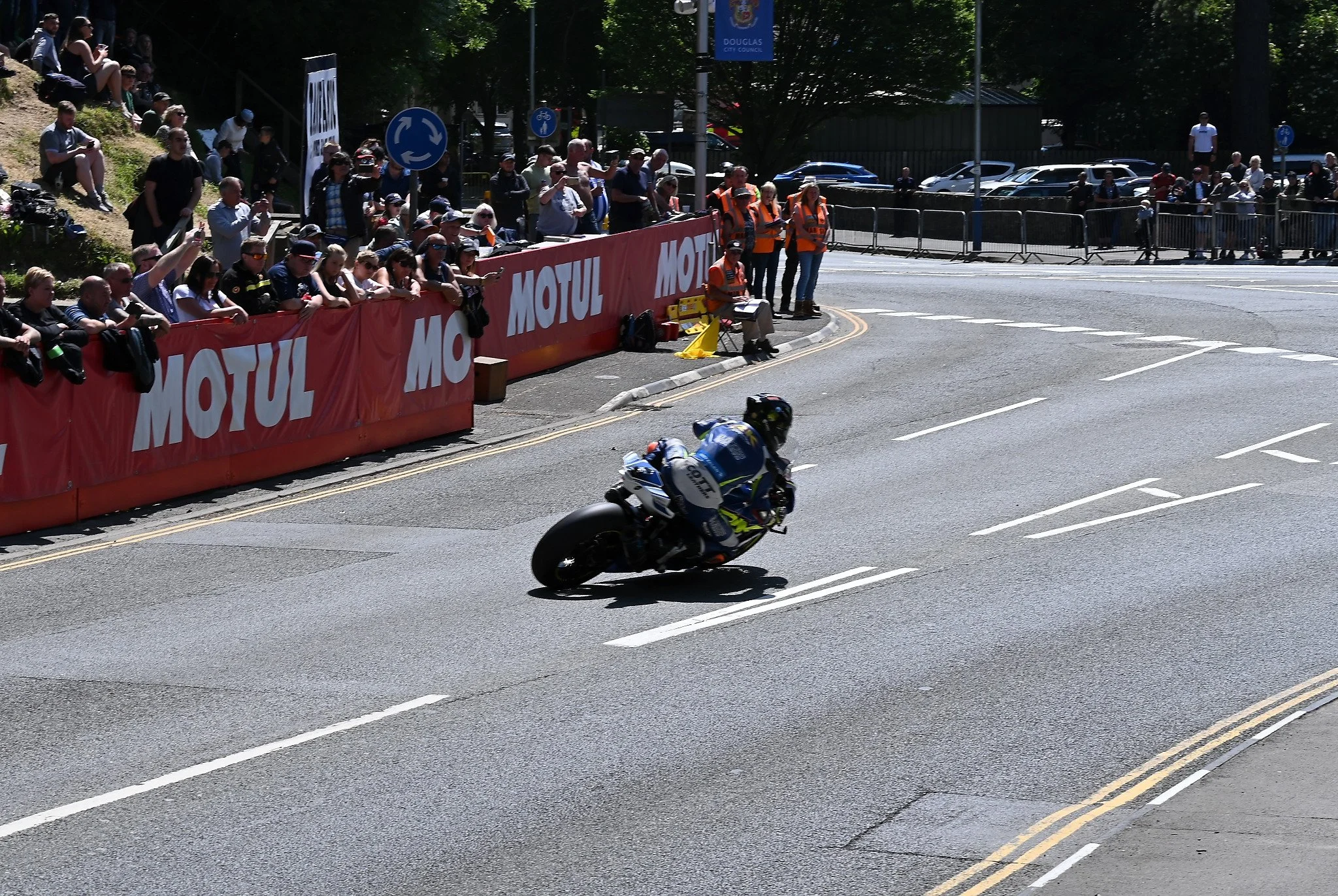 Here #16 Mike Brown begins his turn through the roundabout out of Quarterbridge Road and onto Peel Road. Photo take at Quarterbridge Road. 