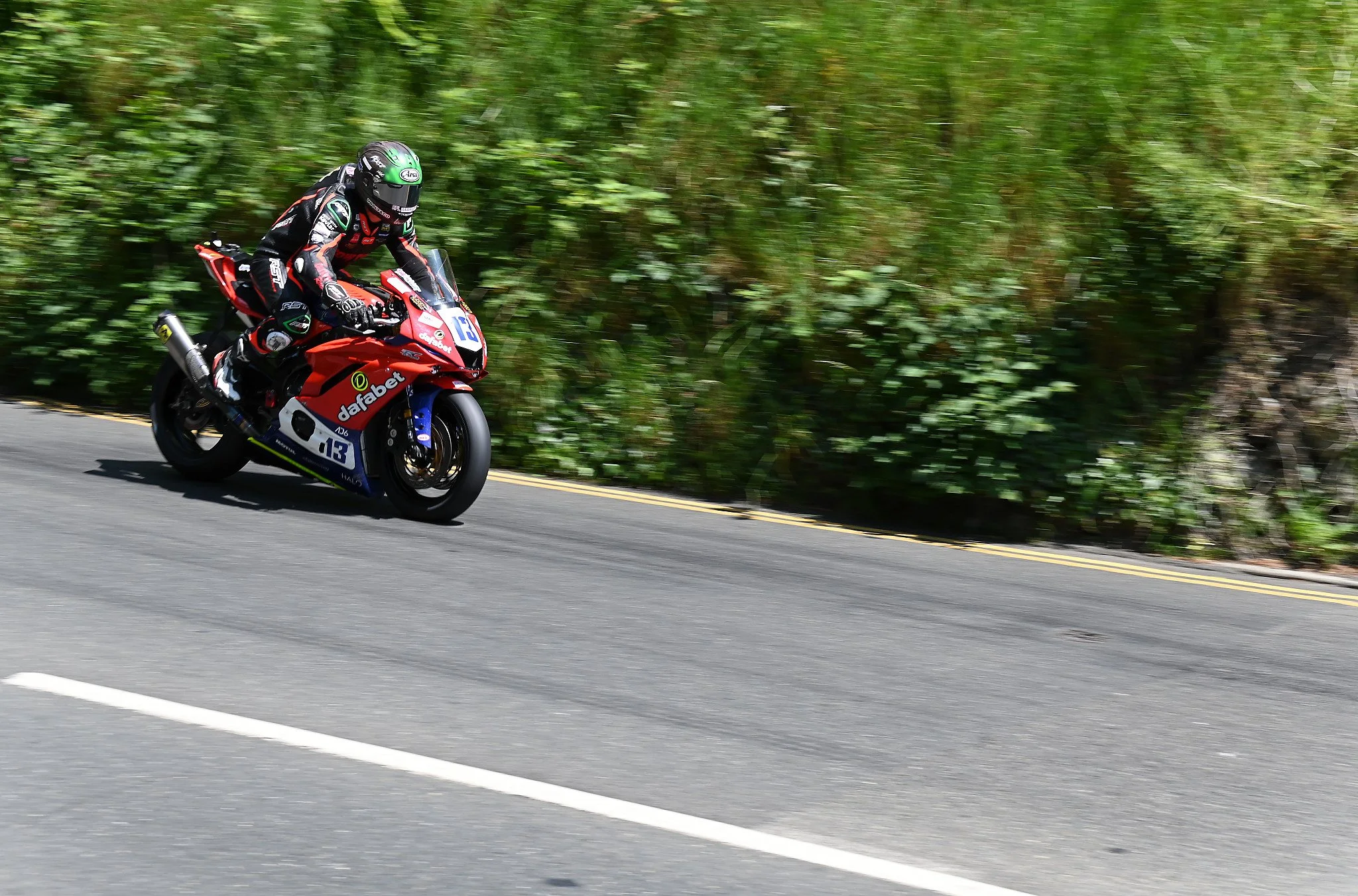 #13 Dominic Herbertson - 600 Kawasaki - Cowton Racing is already hard on the downshift, as you can see by the front forks compressed on the bike. Photo take at Quarterbridge Road. 