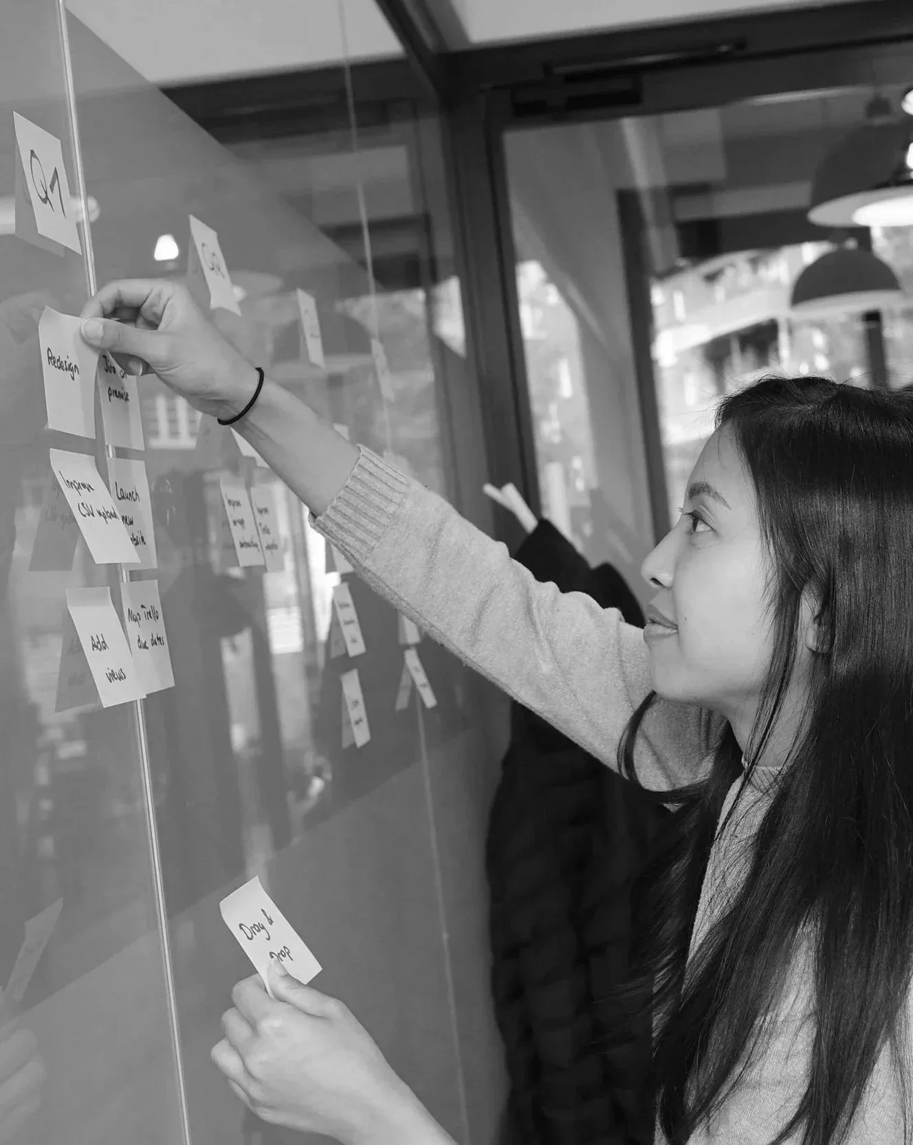Participant mapping ideas and workflows with sticky notes during a collaborative work design session.