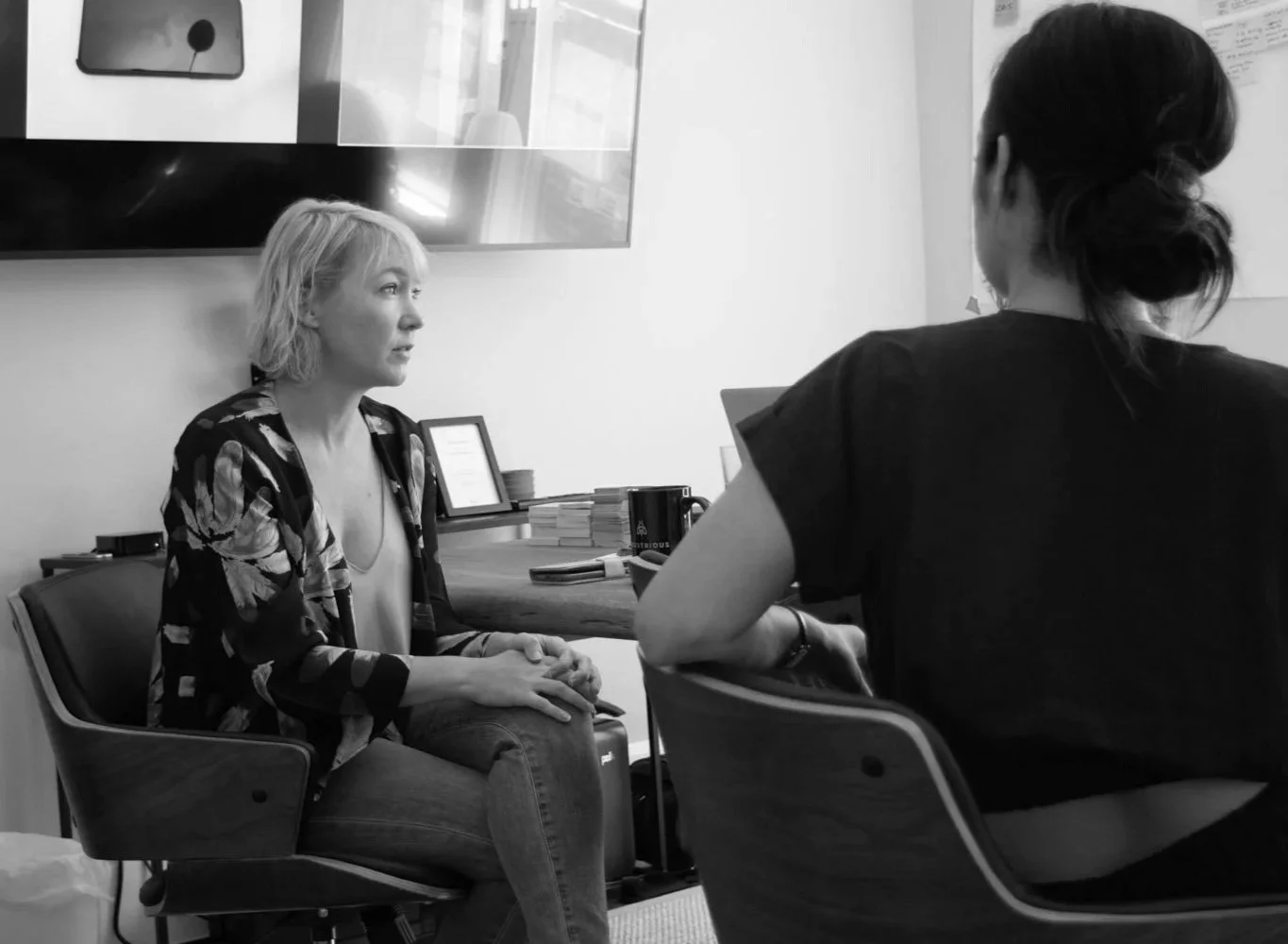 Two people discussing organizational needs during a work design research session.