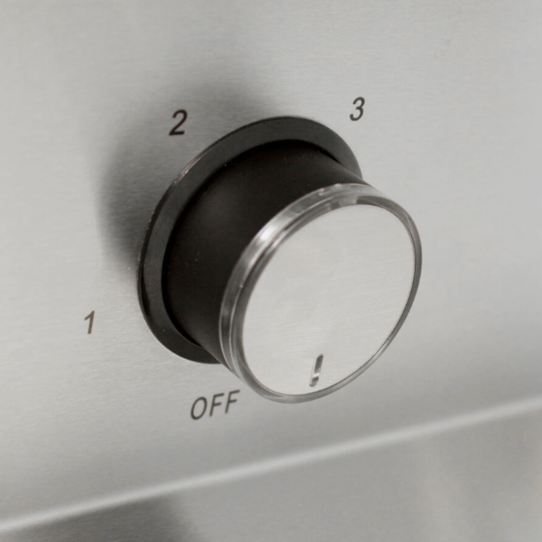 Close-up of a metallic control panel with a black and silver dial numbered 1, 2, and 3, with an OFF position below.