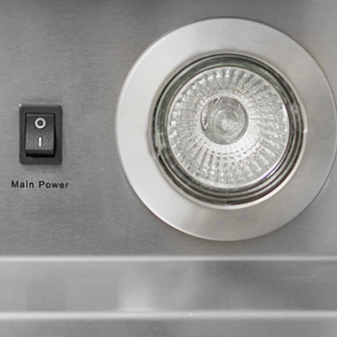 Close-up of a stainless steel oven or microwave with a circular glass turntable and a small black switch labeled Main Power.