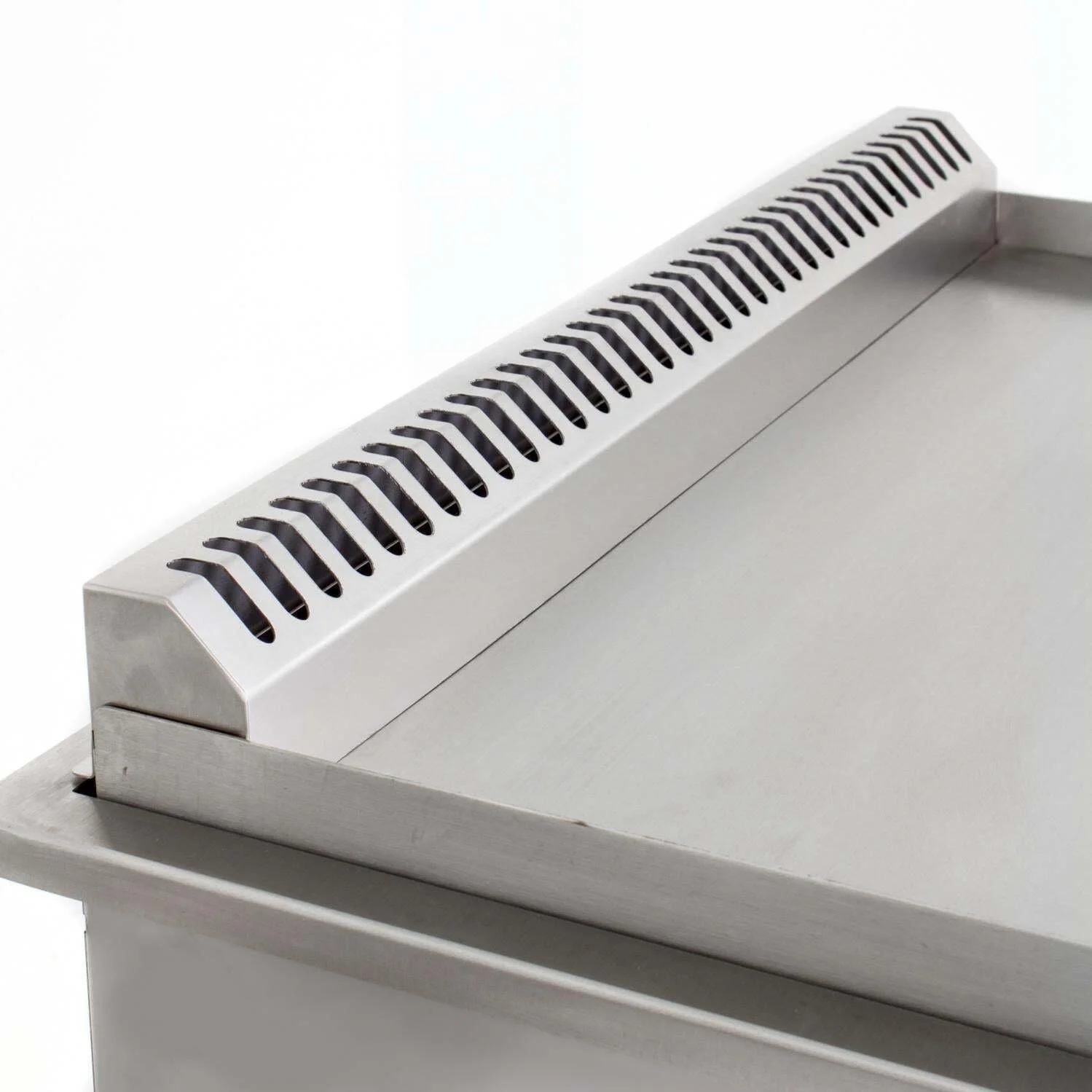 Close-up of a stainless steel commercial food preparation table with a vented metal back splash.