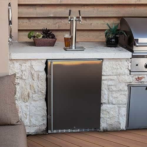 Outdoor outdoor kitchen with a small refrigerator, a sink with a beer tap, potted plants, and a grill, set against a wooden wall.