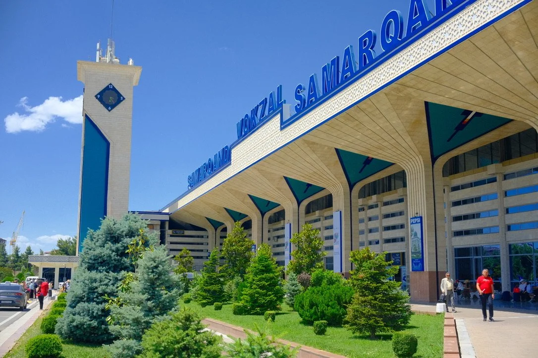 Exterior of Samarkand Vokzal train station with clock tower and Soviet-era architecture, Samarkand, Uzbekistan