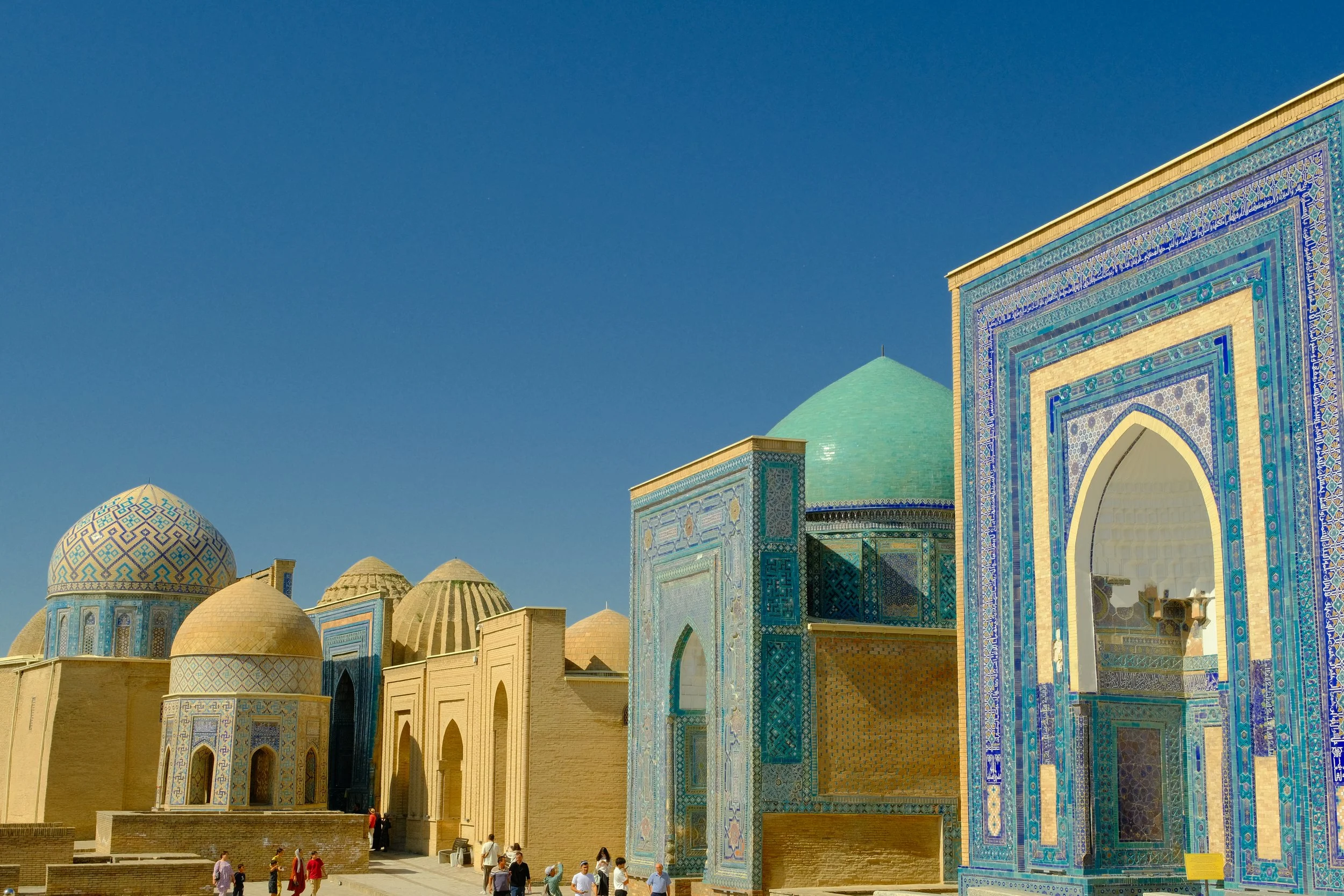 Cluster of ornate geometric-tiled mausoleums with gold and turquoise domes at the Shah-i-Zinda necropolis, Samarkand, Uzbekistan