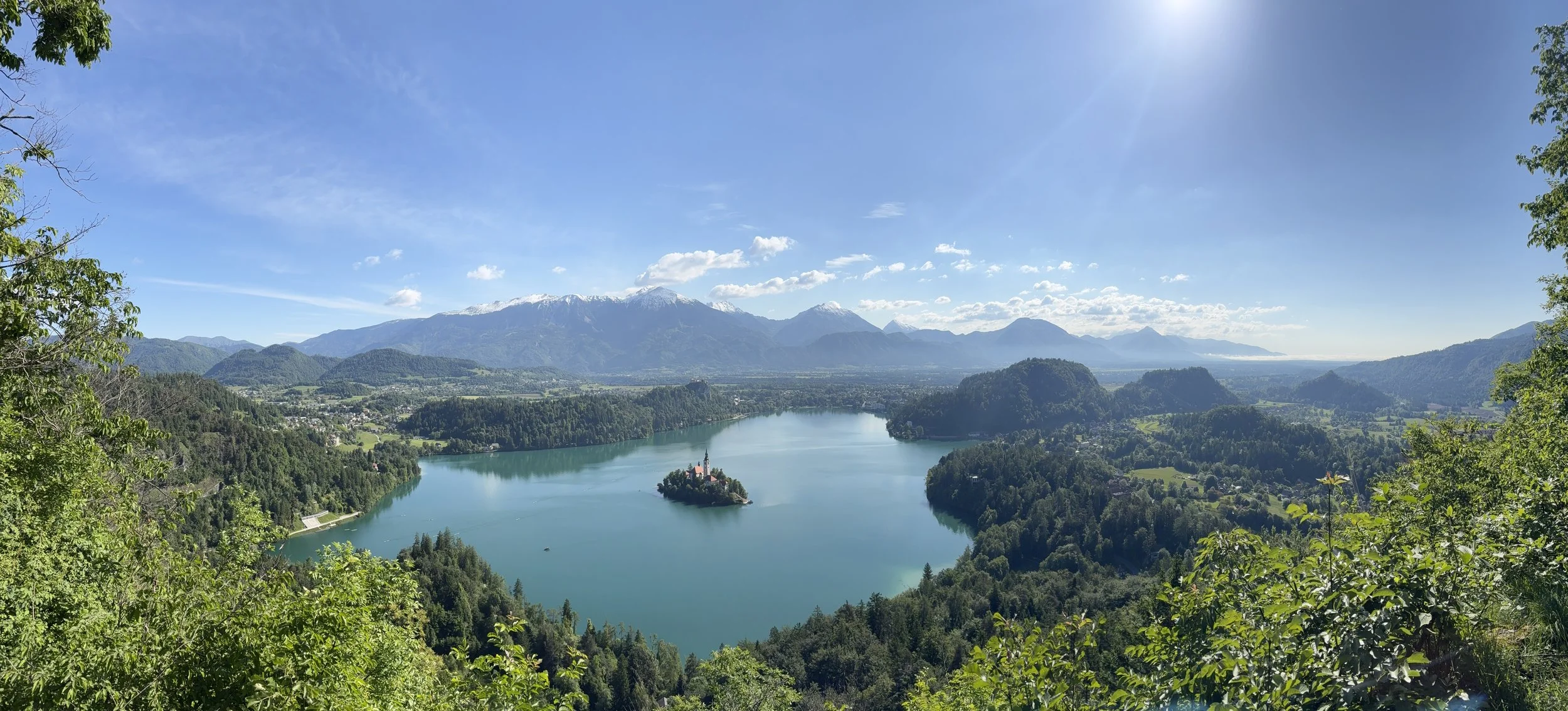 Aerial view of Lake Bled with Bled Island and its church surrounded by turquoise water and the Julian Alps in the background, Slovenia