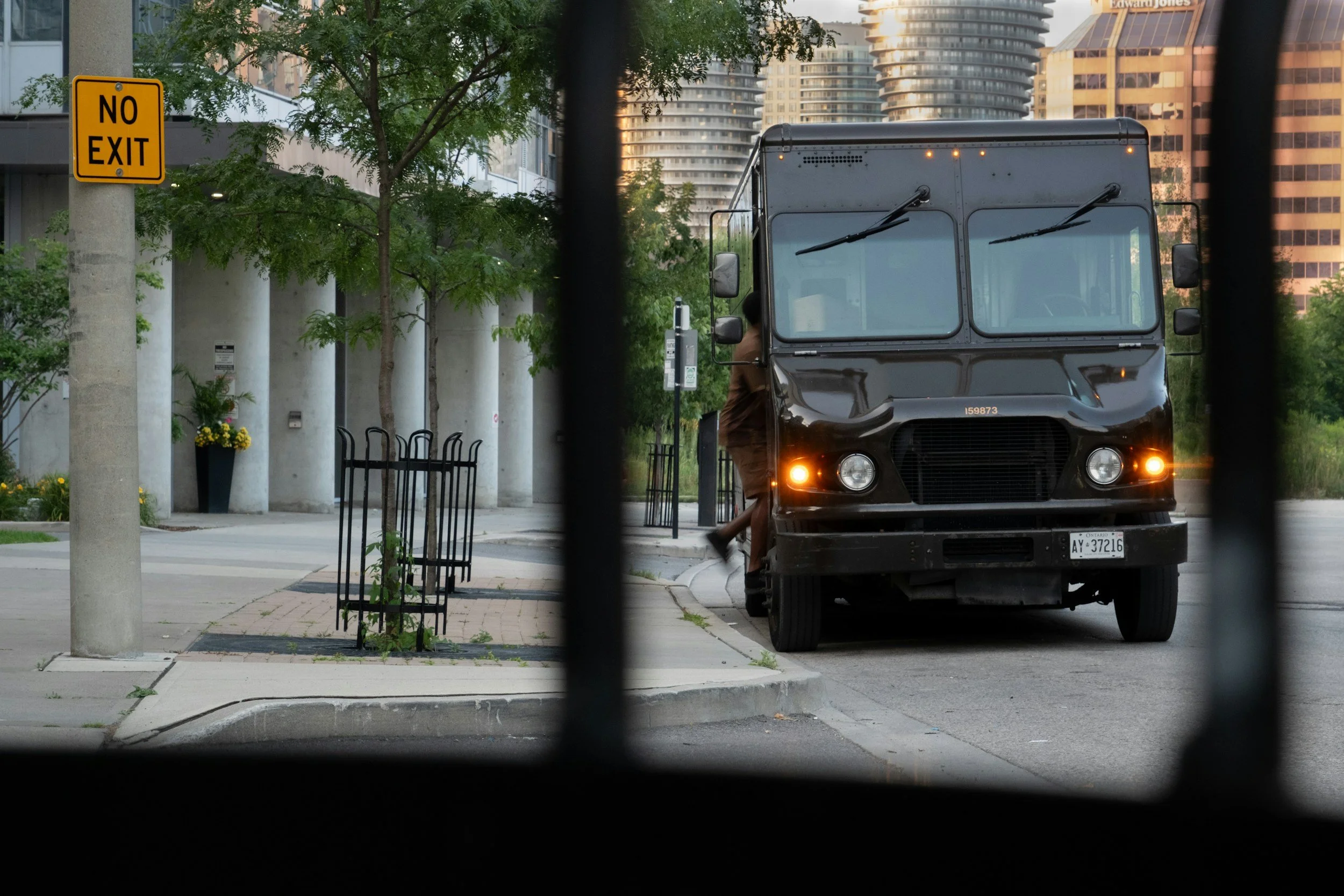 Commercial cannabis delivery truck parked on a city street.