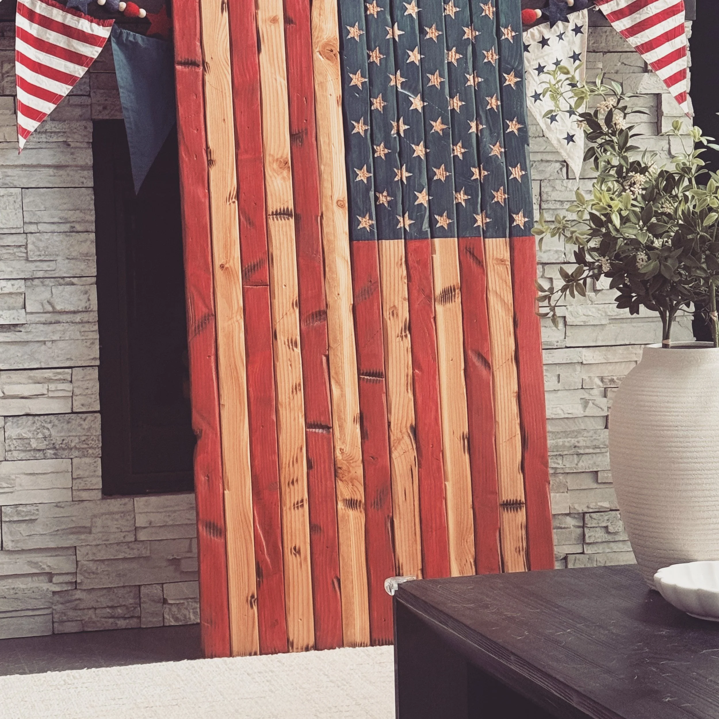Built to be handed down.

Our 5-foot handcrafted wooden American flag is made one board at a time, highlighting the natural beauty of real wood while honoring the flag we all stand behind.

Built to become the centerpiece of any room.
Built to last.
