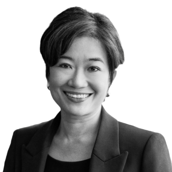 Black and white headshot of a smiling woman with short hair, wearing a dark blazer.