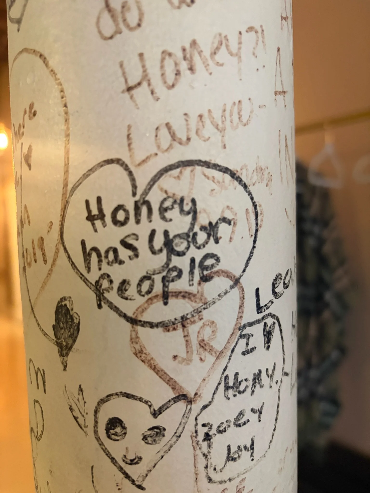 Handwritten notes on a white cylindrical surface, with hearts and smiley faces, expressing gratitude and kindness.