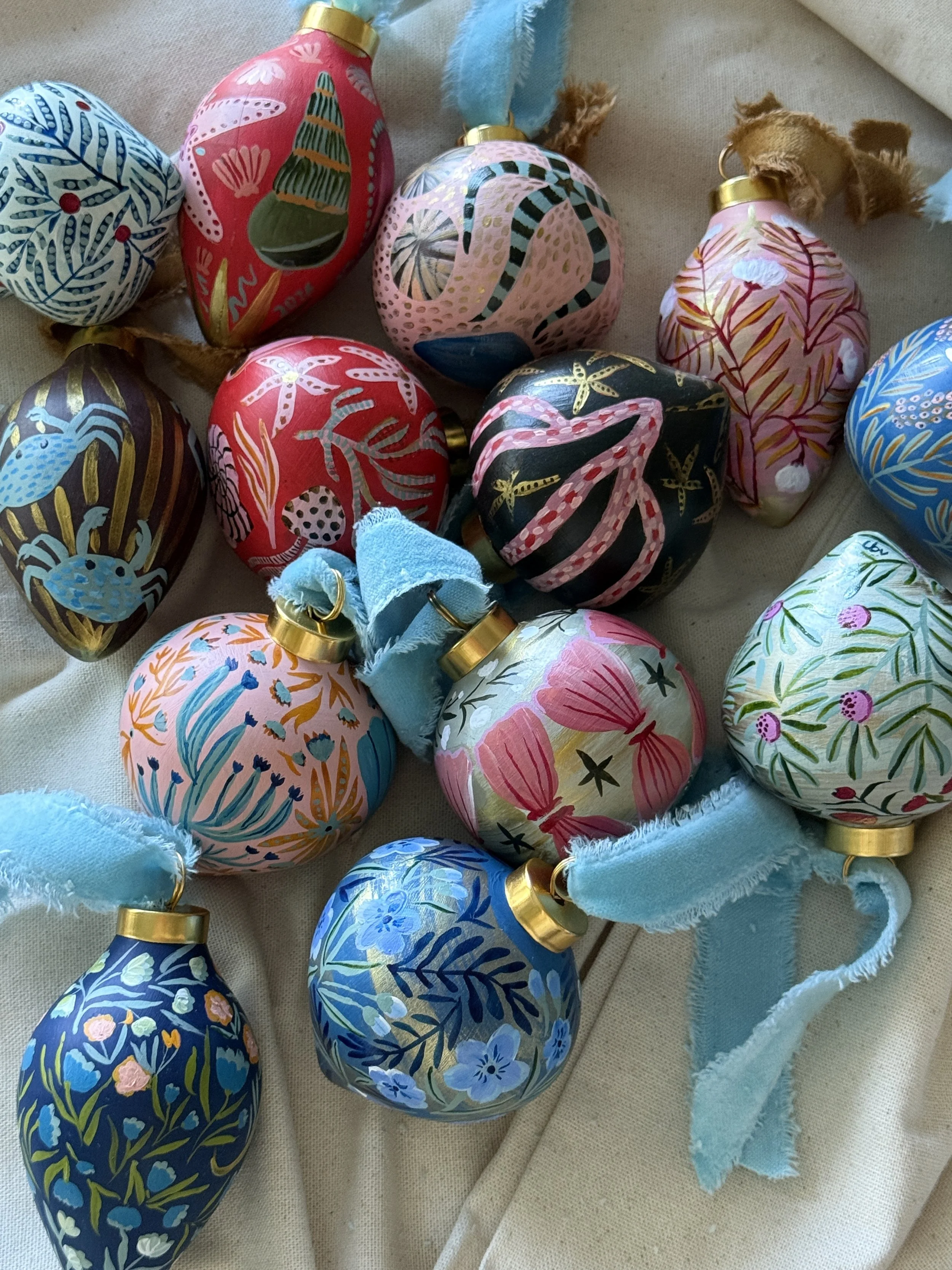 collection of Christmas ornaments by cris villa with botanical and sea life themes