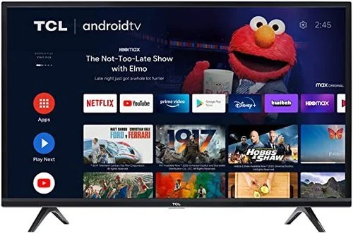 TCL smart TV screen displaying various streaming apps, Elmo puppet, and movie titles like 'Ferrari' and 'Hobbs & Shaw'.